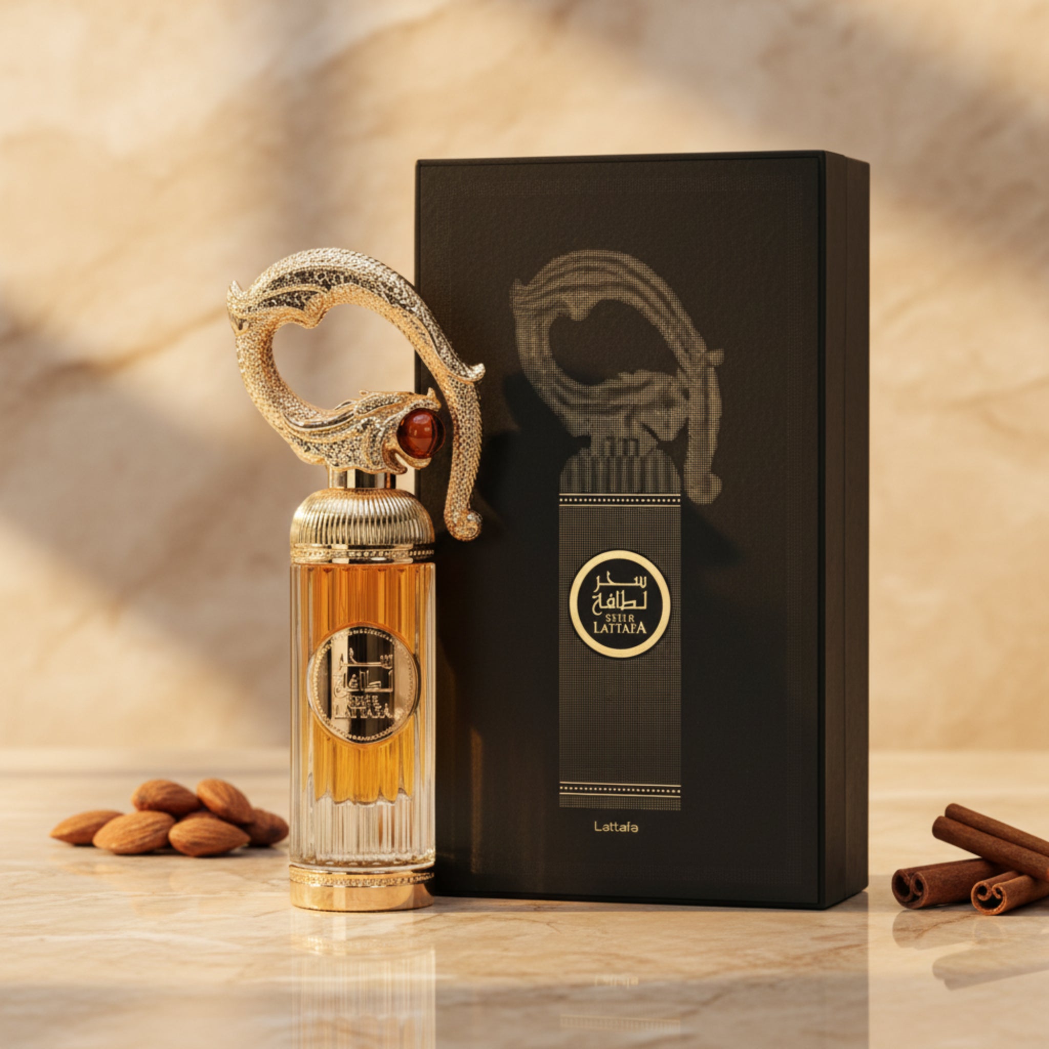 Perfume bottle with gold accents and a black box featuring a brand logo on a white background