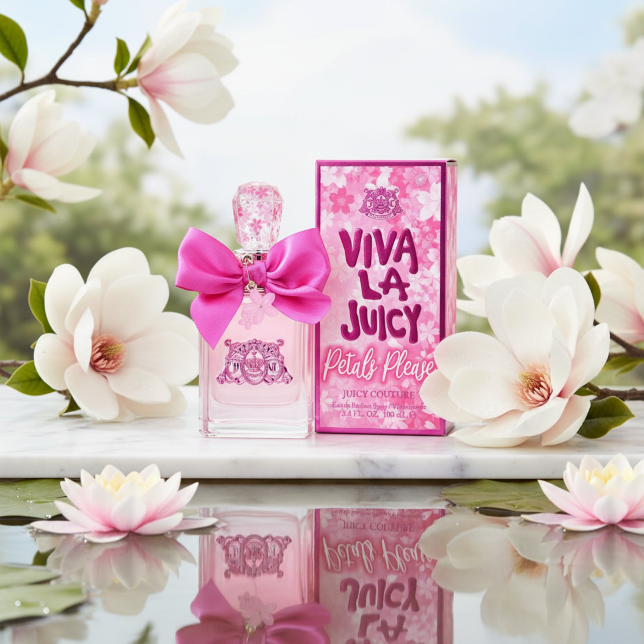 Viva La Juicy Petals Please by Juicy Couture perfume bottle and box on a marble with water lilies
