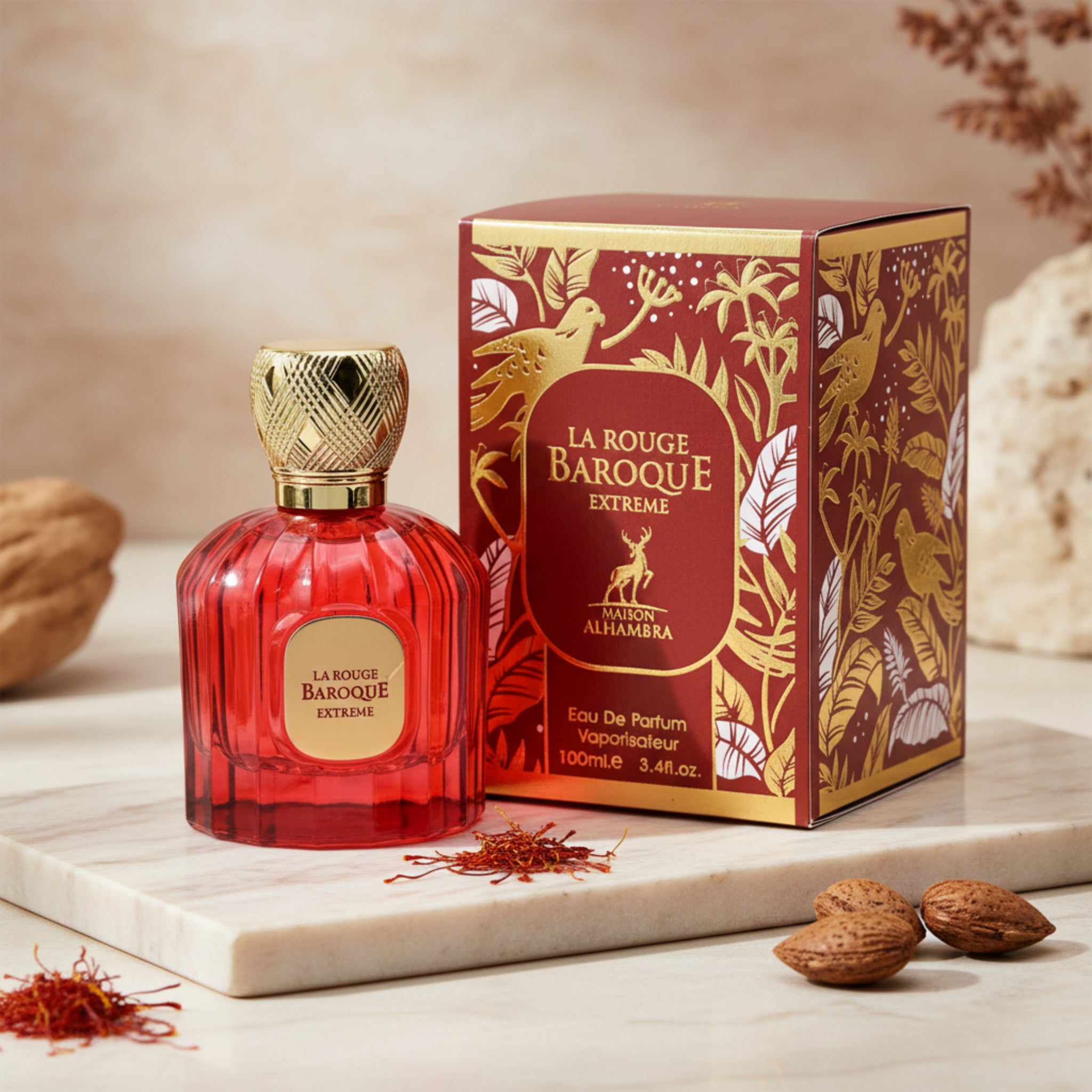 Red perfume bottle with gold cap and decorative box on a white background