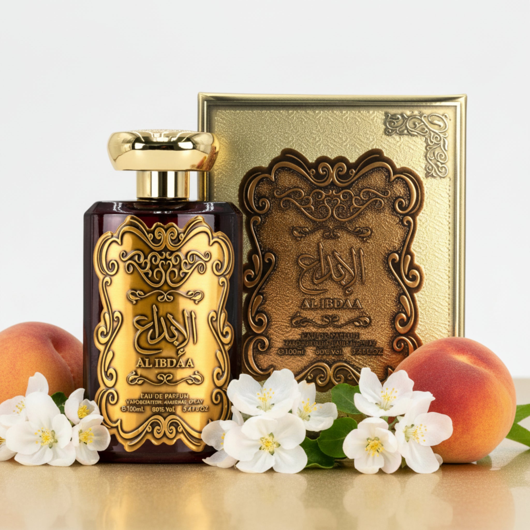 Perfume bottle and packaging with intricate designs on a white background