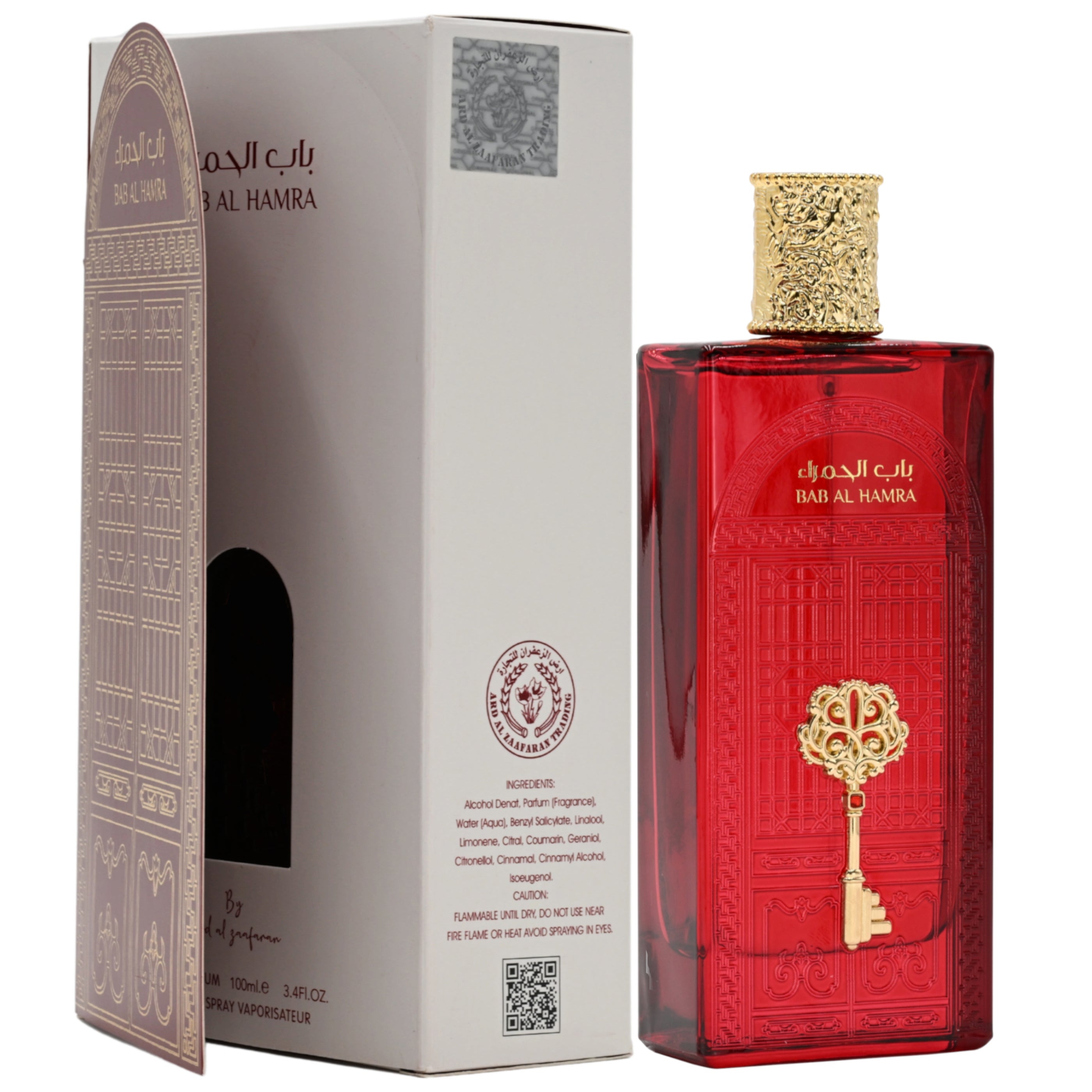 Red perfume bottle with gold key design next to its packaging on a white background