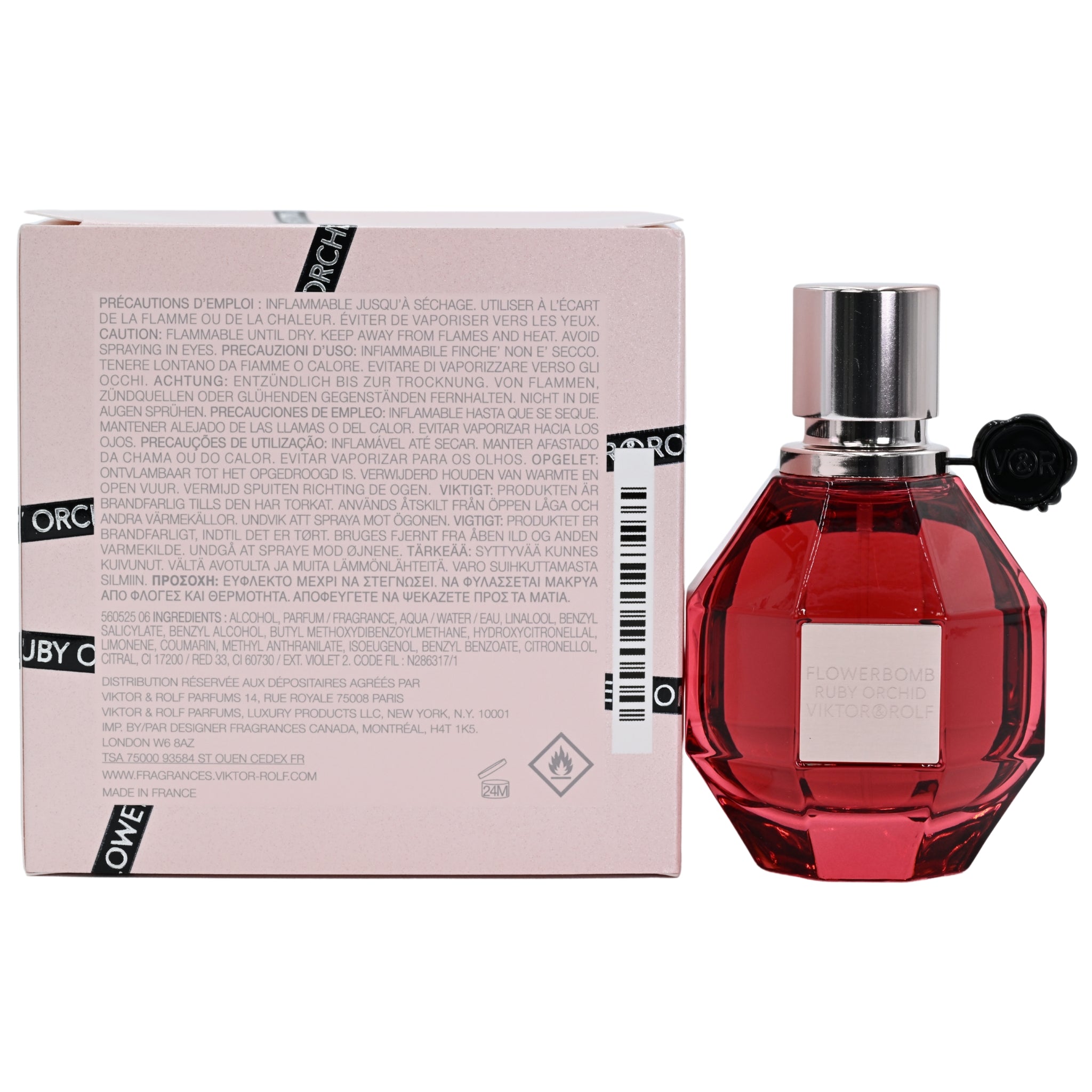 Red perfume bottle with silver cap and black nozzle next to its packaging on a white background