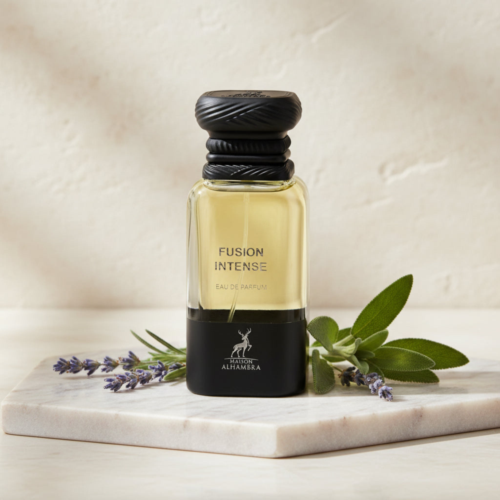 Fusion Intense perfume bottle with lavender and sage leaves on a marble surface