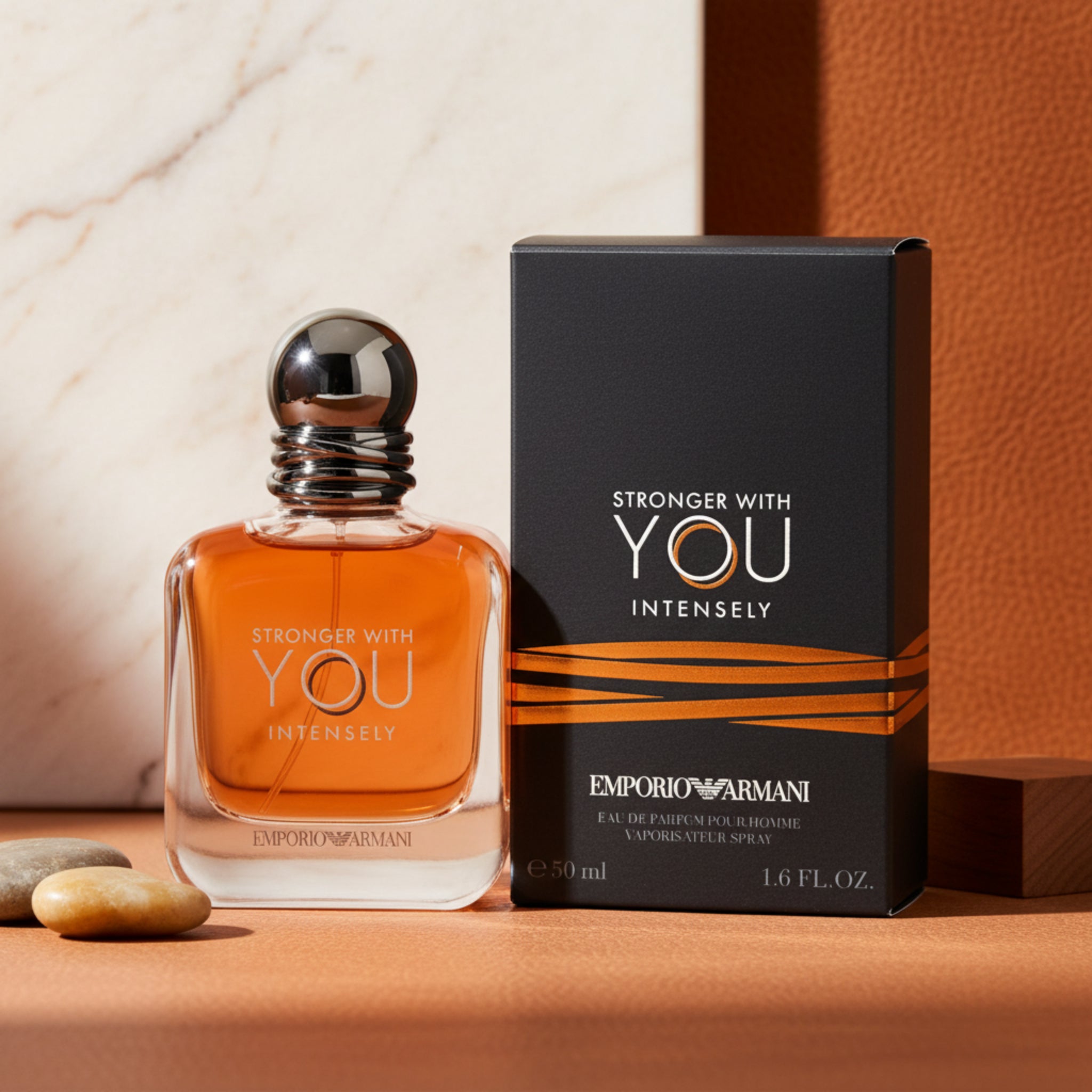 Orange perfume bottle with black cap and Emporio Armani packaging on a white background