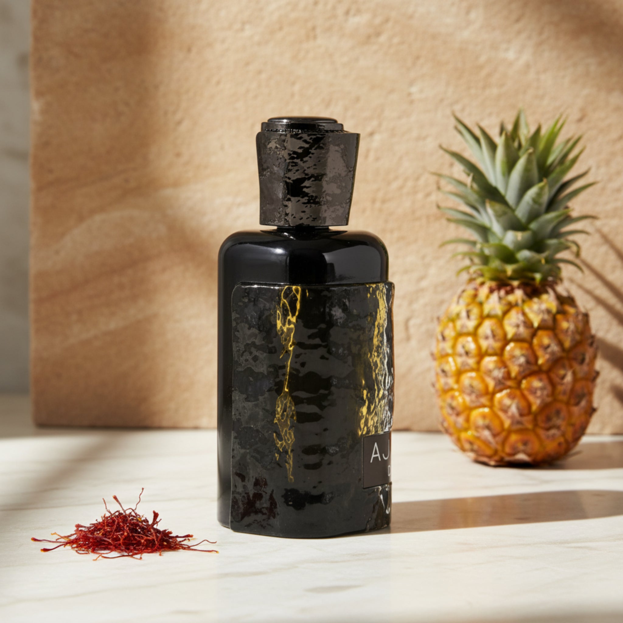 Black perfume bottle with gold accents on a white background