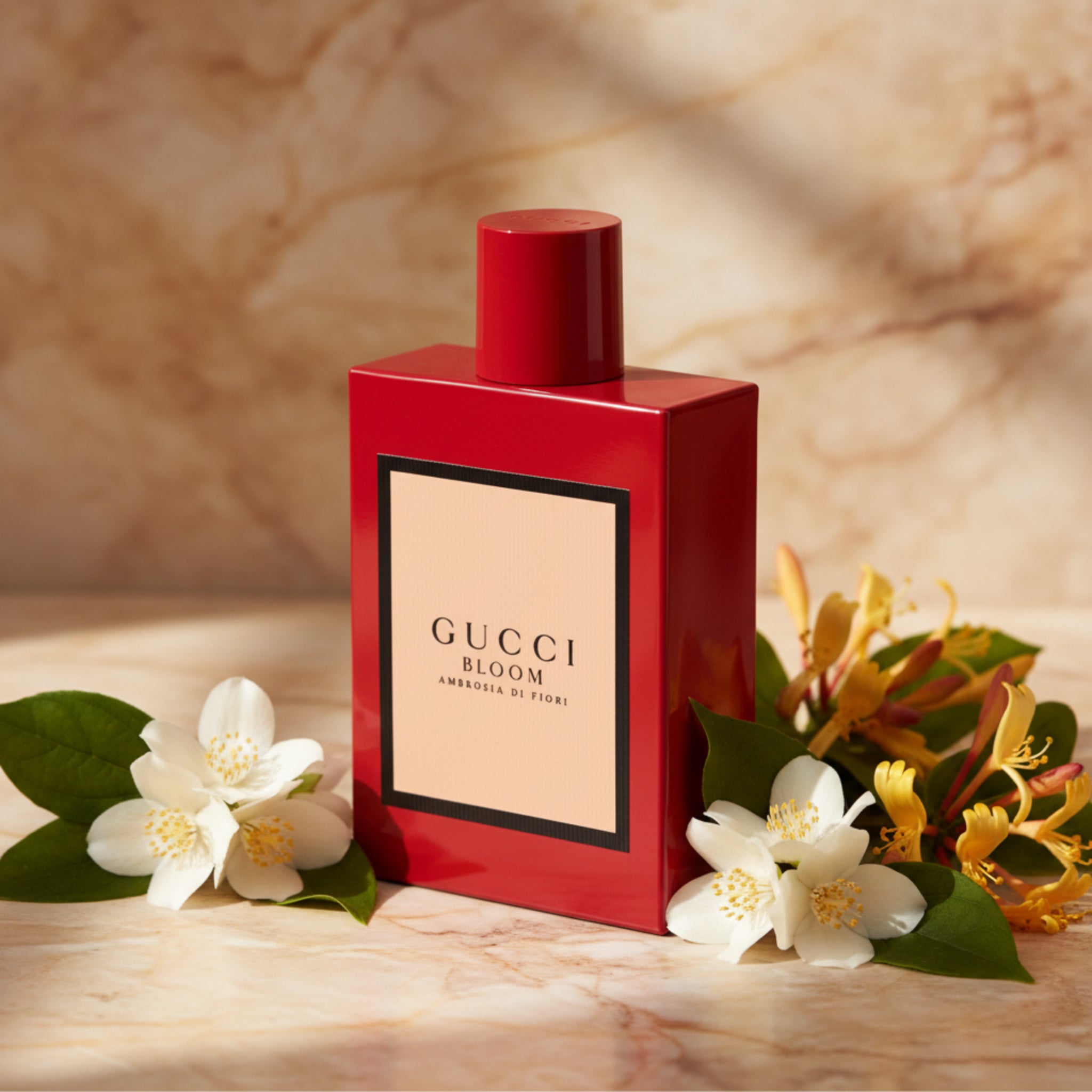 Red Gucci Bloom perfume bottle on a white background