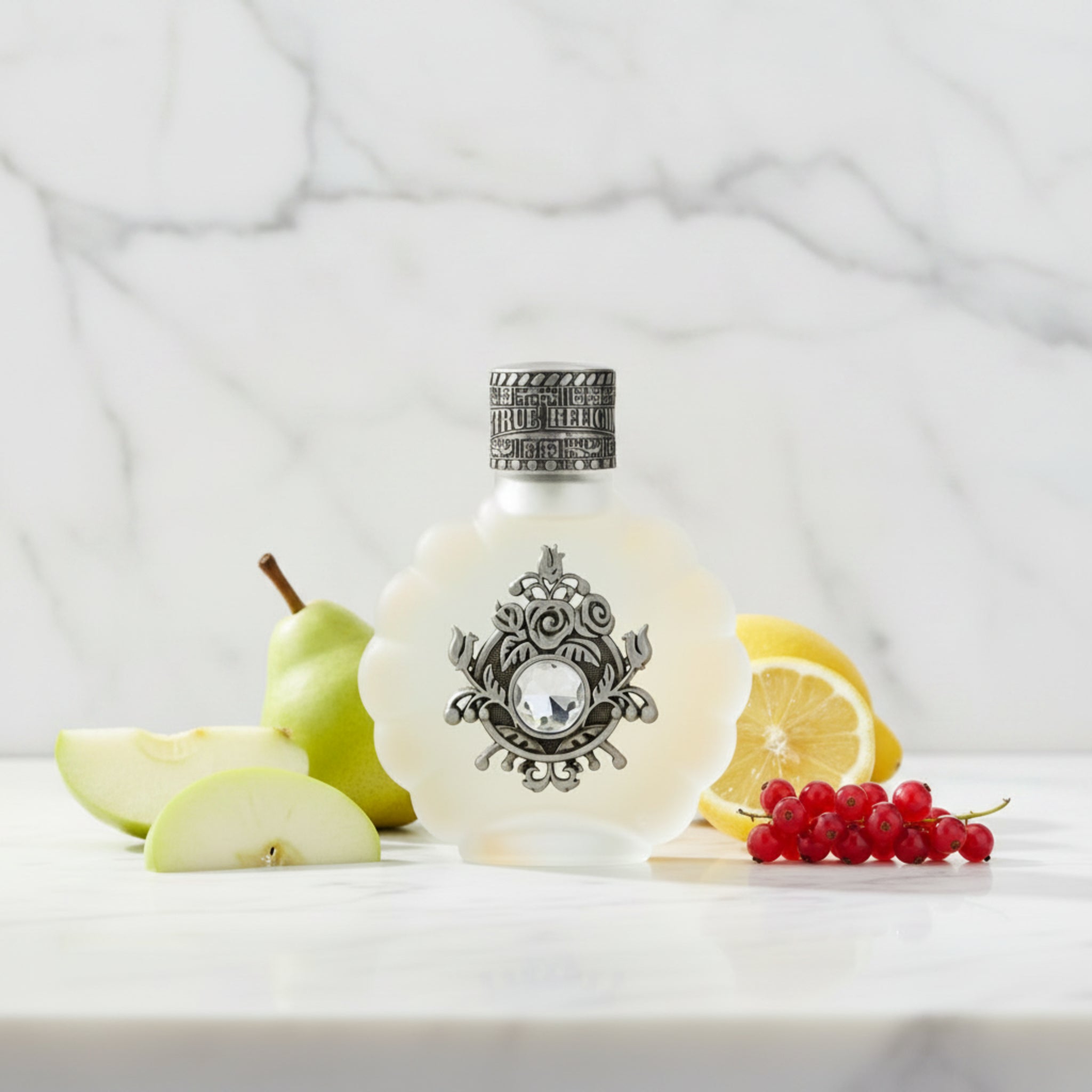 Decorative perfume bottle with intricate silver design on a white background