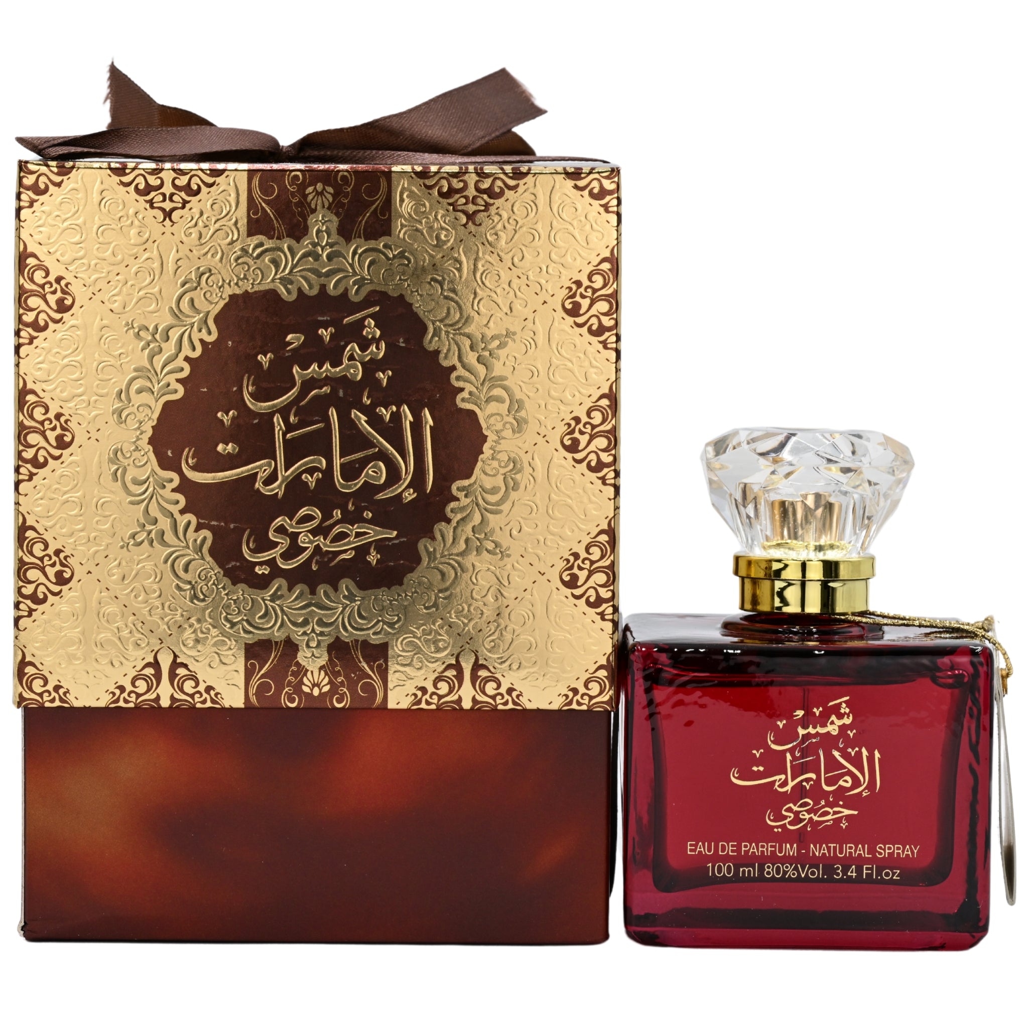 Red perfume bottle with gold cap next to its decorative box on a white background