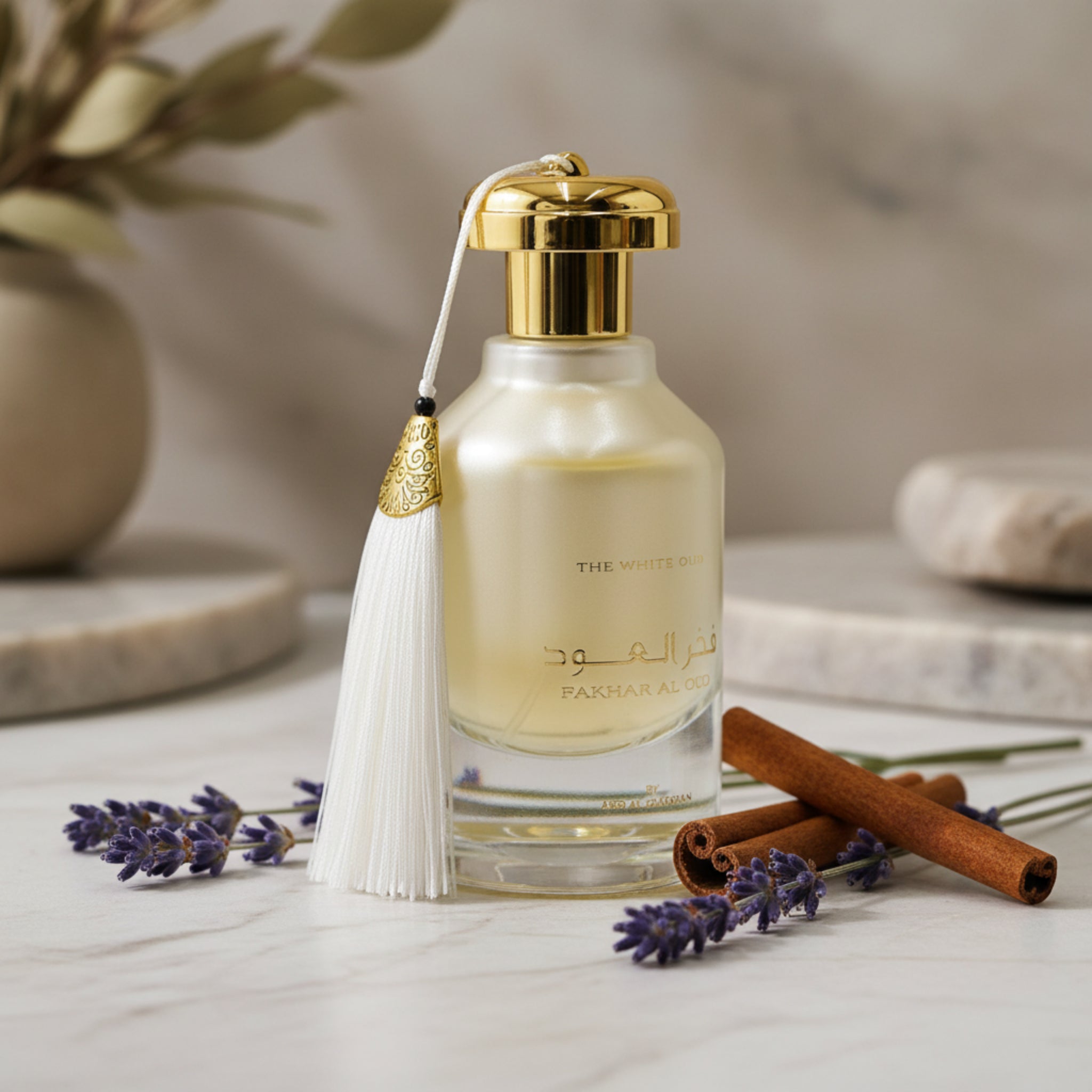 Perfume bottle with gold cap and decorative elements on a white background