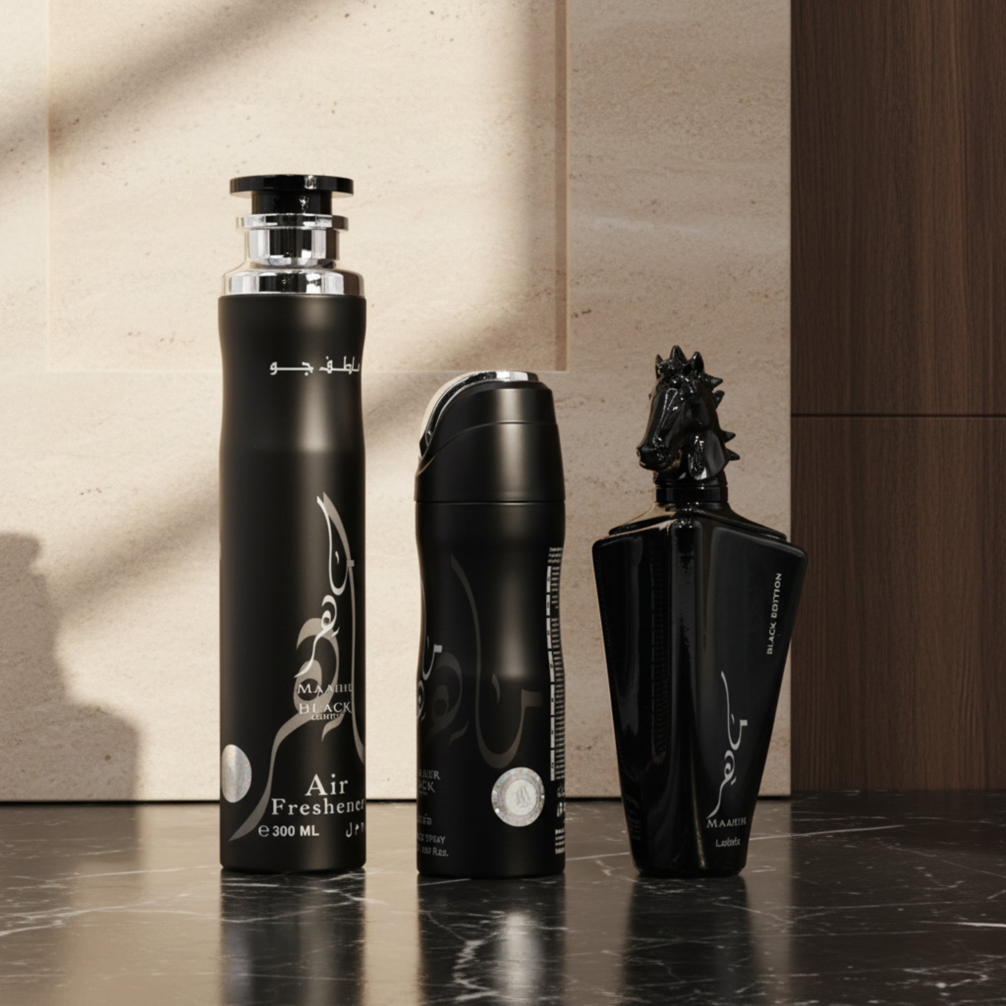 Three black air freshener bottles with different designs on a white background
