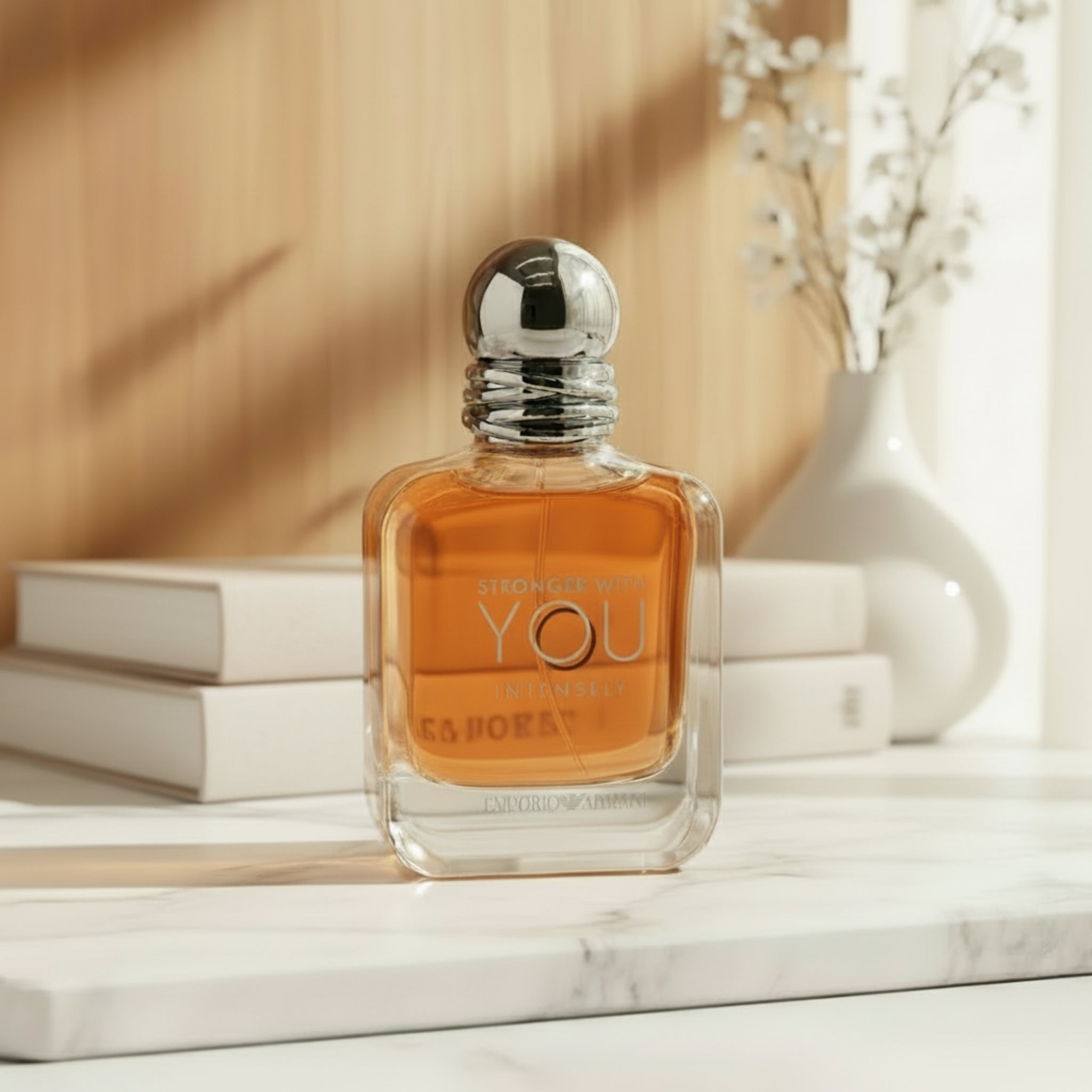 Perfume bottle with 'Stronger with You Intensely' text on a white background