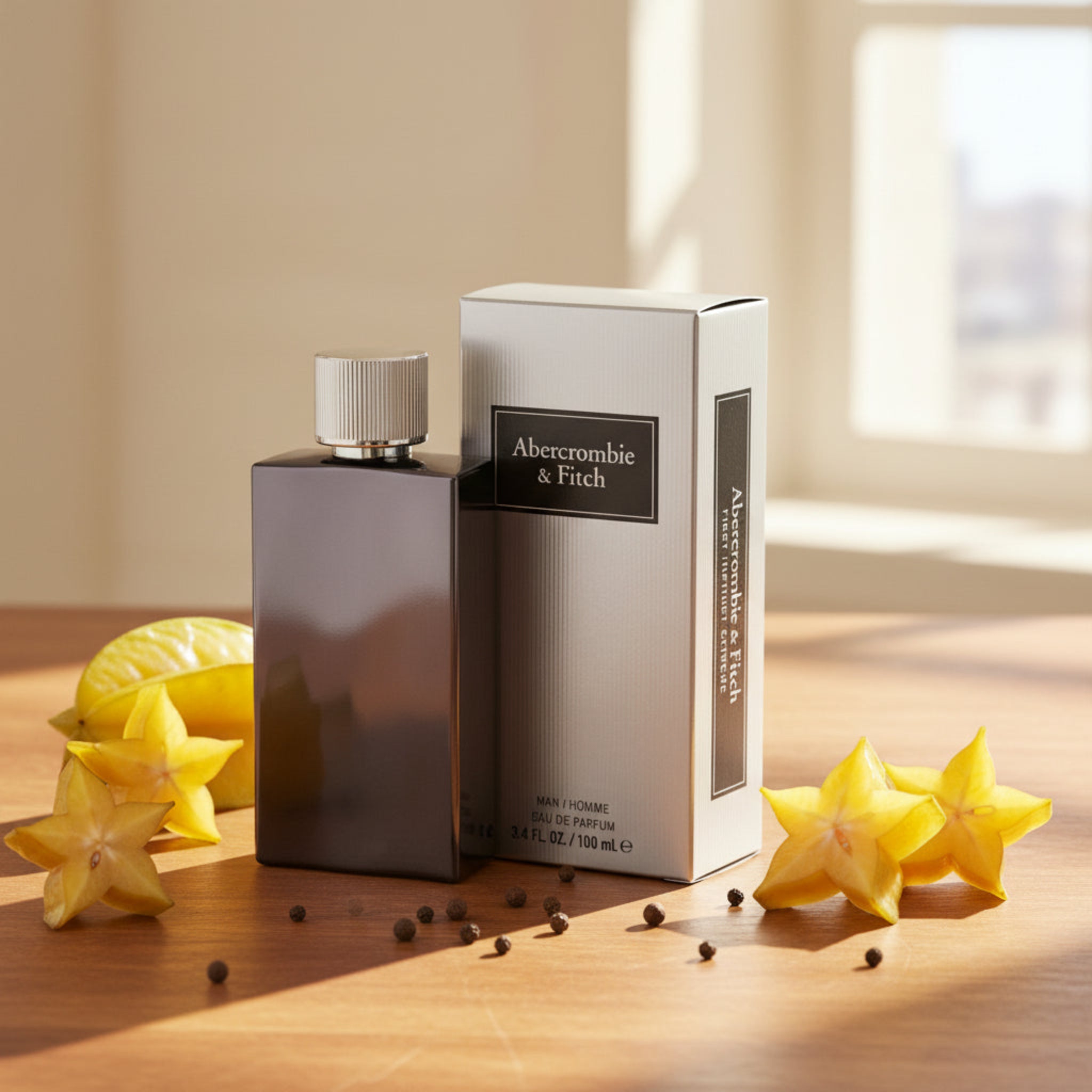 Abercrombie & Fitch perfume bottle and packaging on a wooden surface with starfruit.