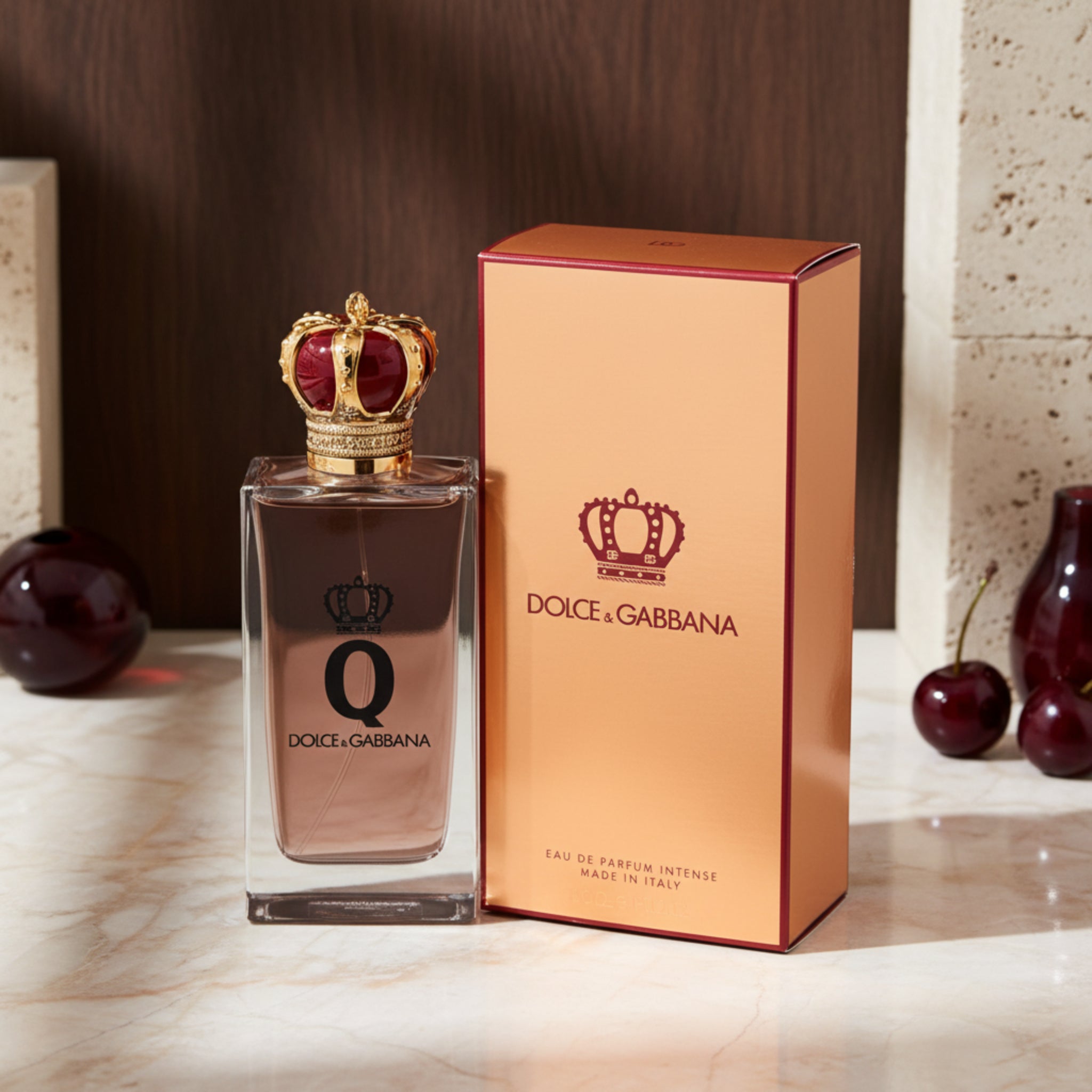 Dolce & Gabbana perfume bottle with gold crown and packaging on a white background