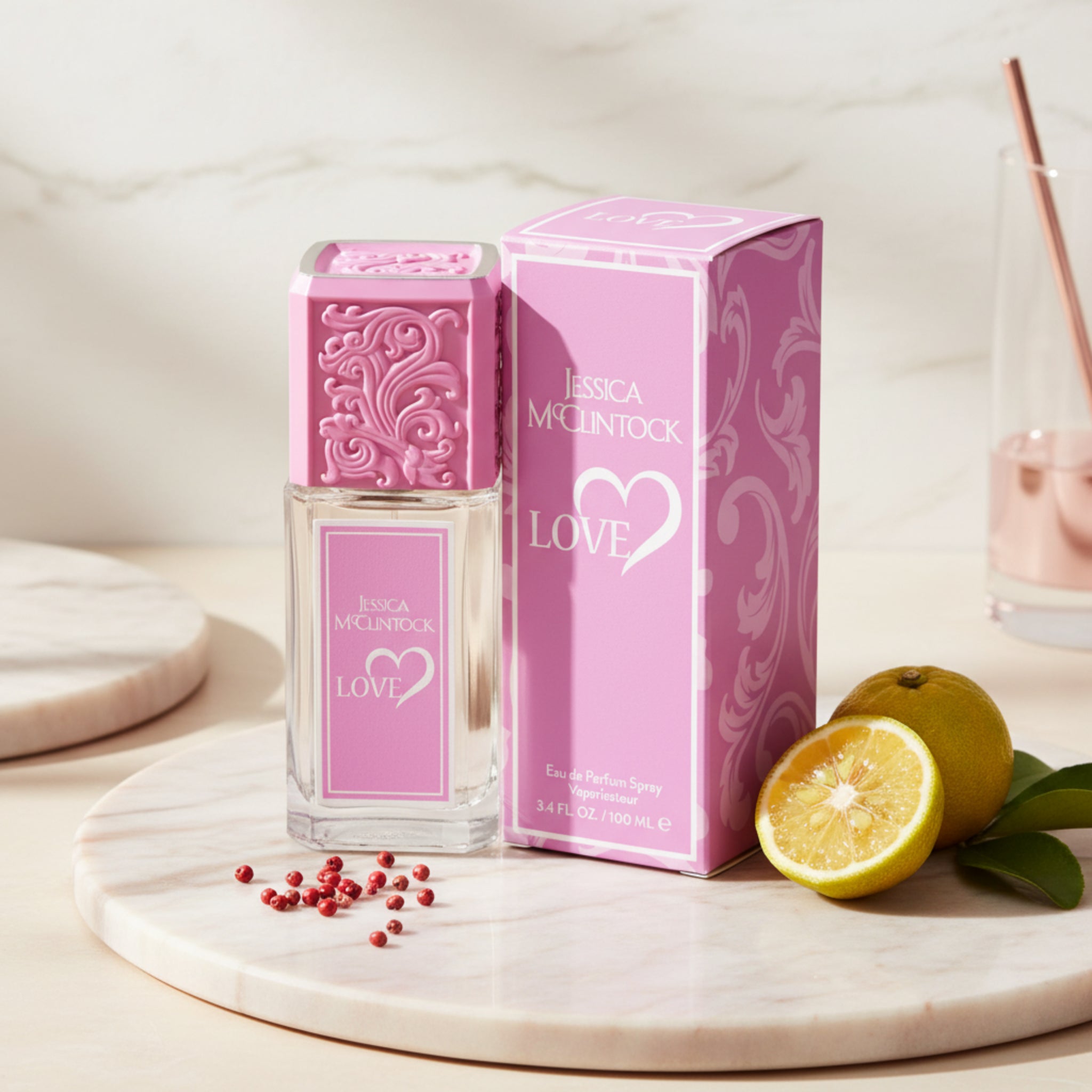 Pink Jessica McClintock Love perfume bottle and packaging on a white background