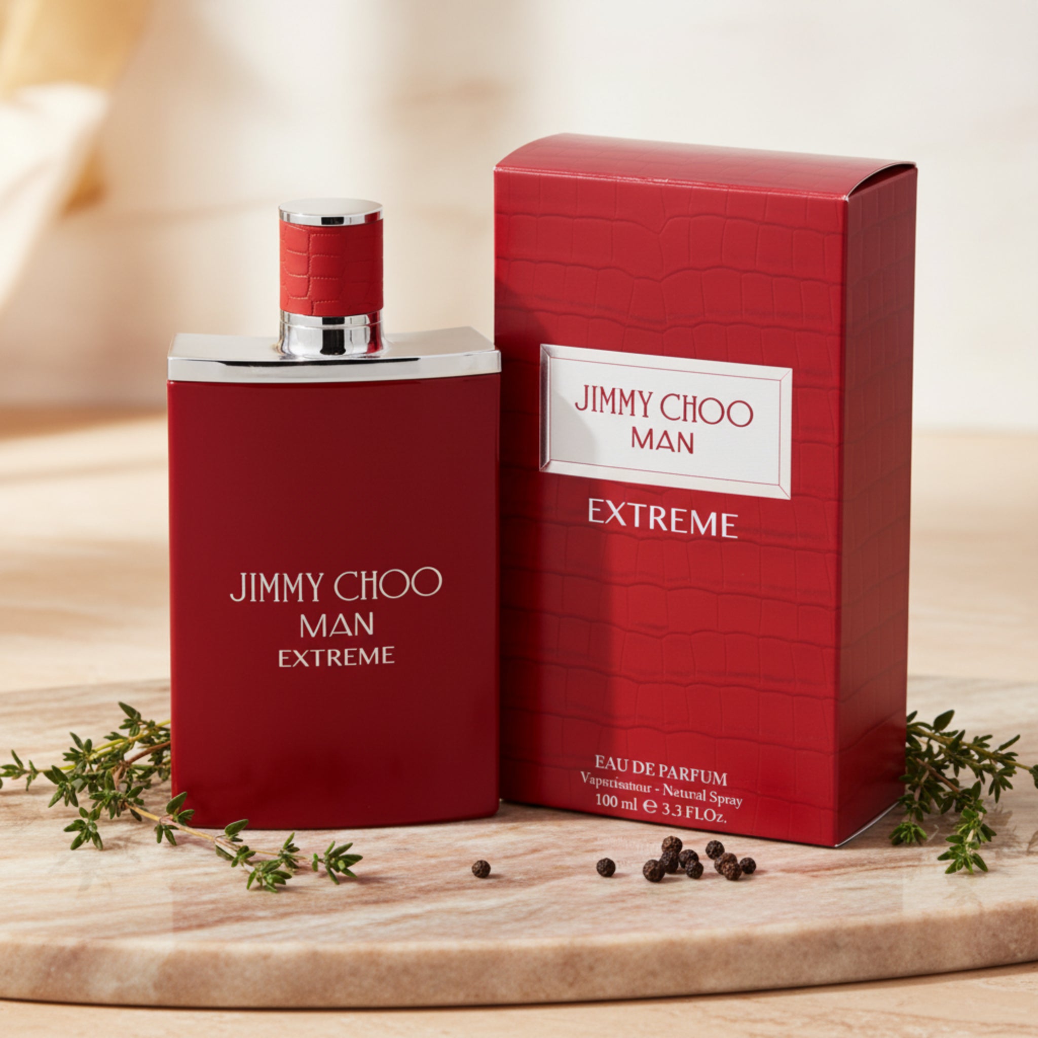 Red Jimmy Choo Man Extreme perfume bottle and packaging on a white background