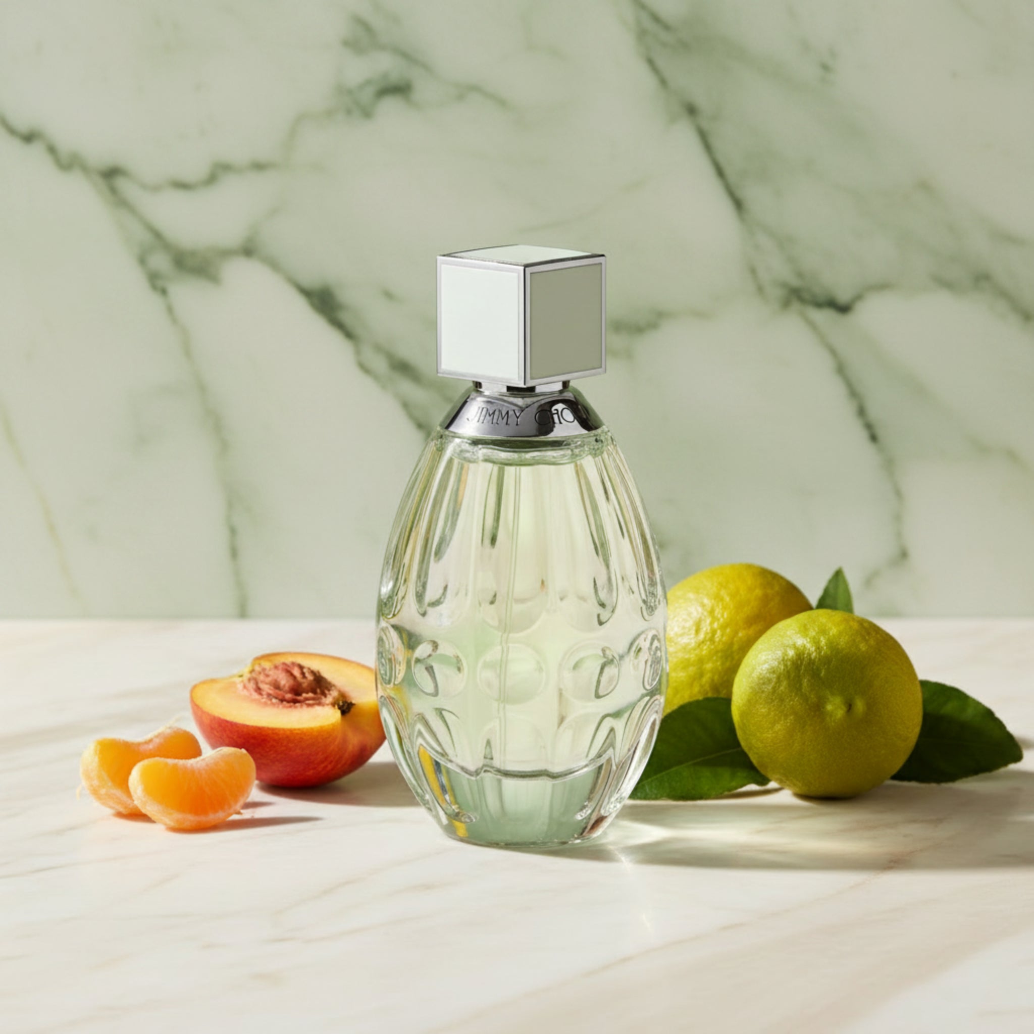 Perfume bottle with silver cap on a white background