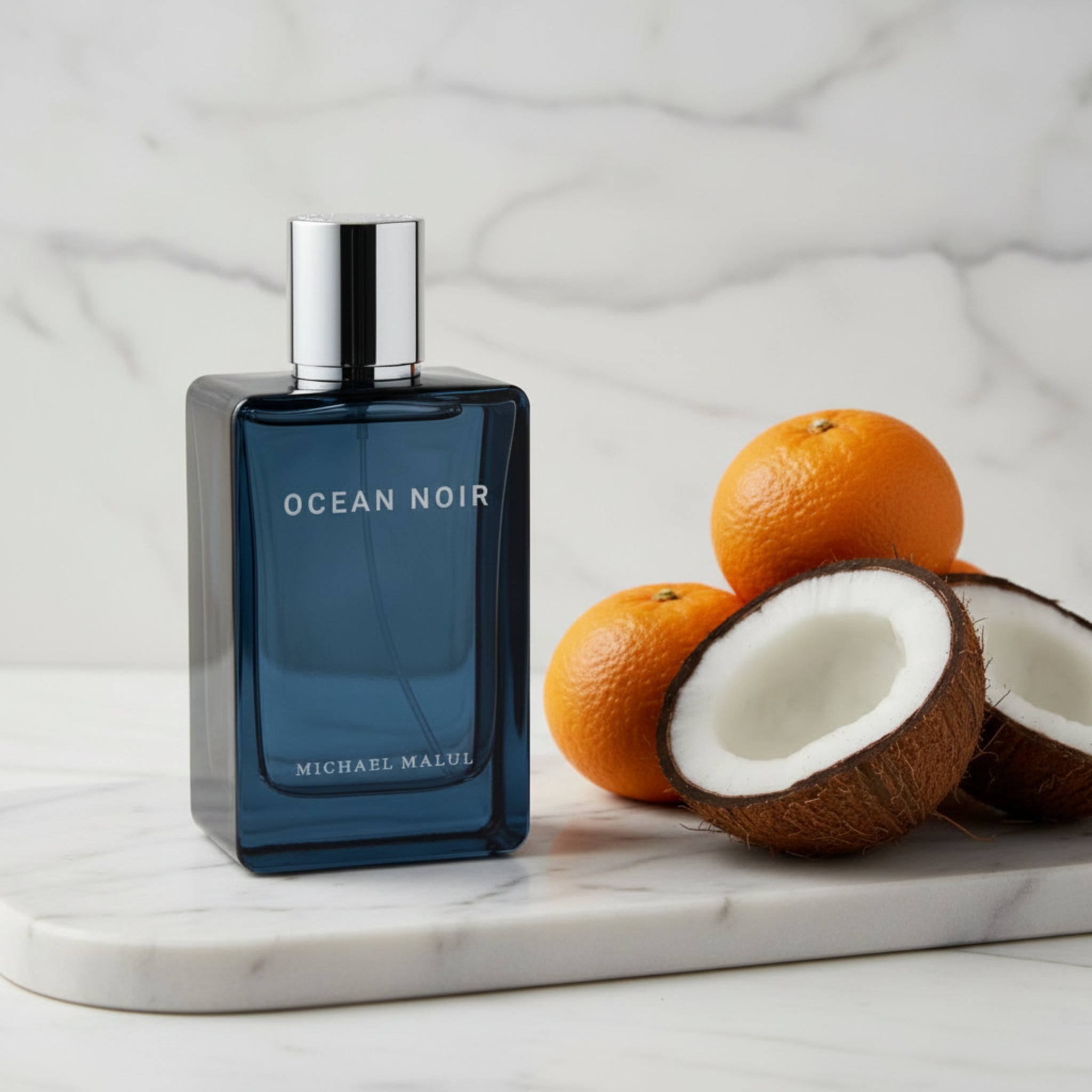 Blue perfume bottle labeled 'Ocean Noir' by Michael Malul on a white background