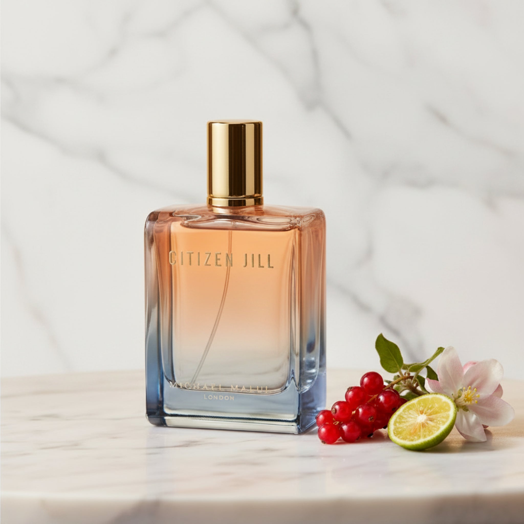 Perfume bottle with gradient design and gold cap on a white background