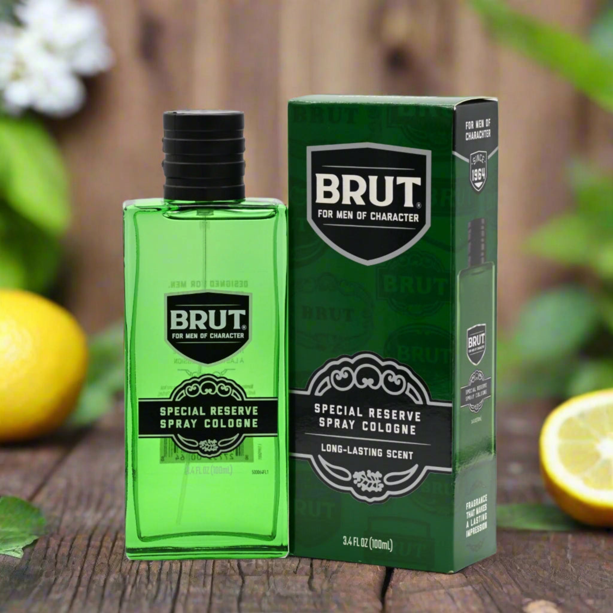 Brut cologne bottle and packaging on a wooden surface with lemons and flowers in the background