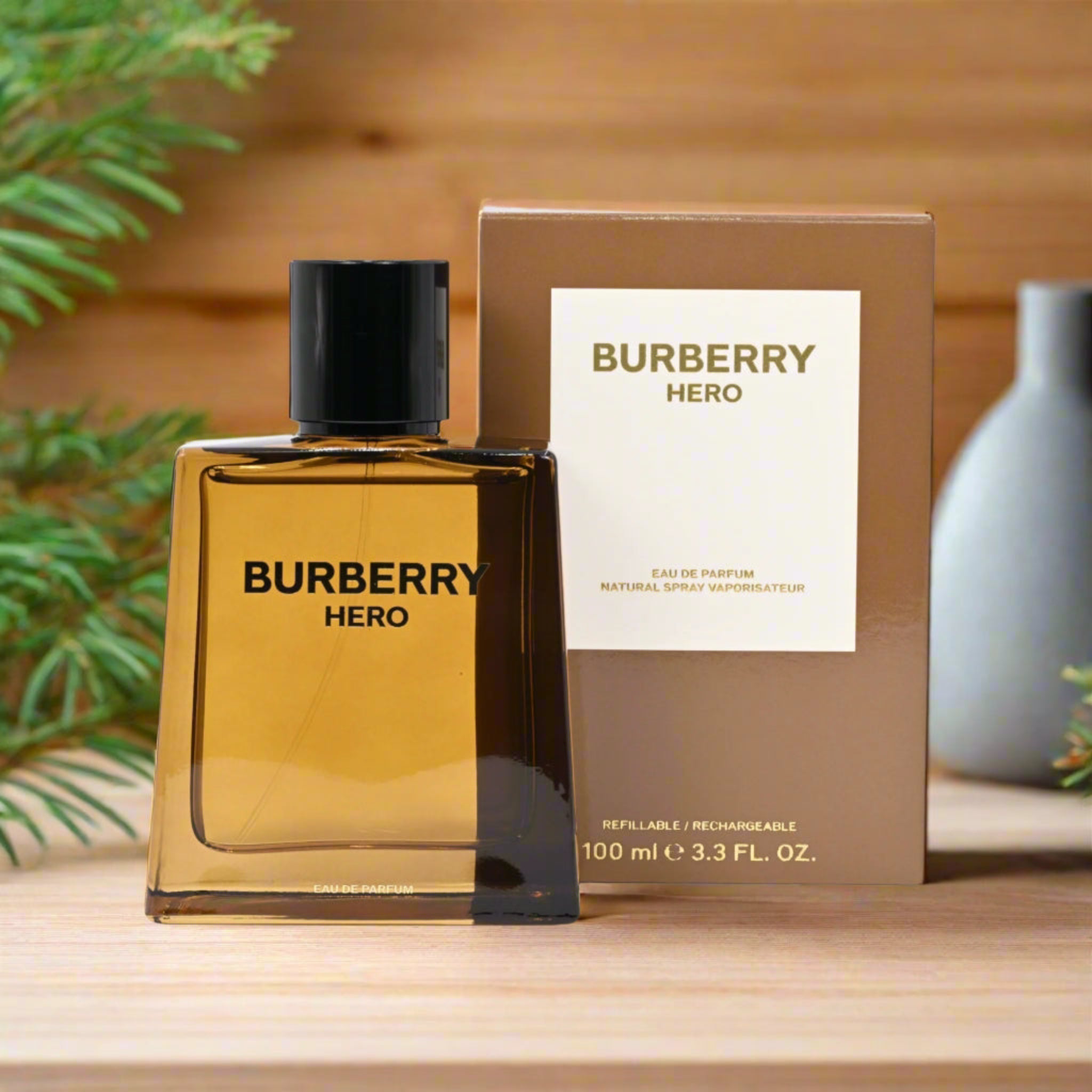 Burberry Hero perfume bottle and packaging on a wooden surface with a blurred plant in the background