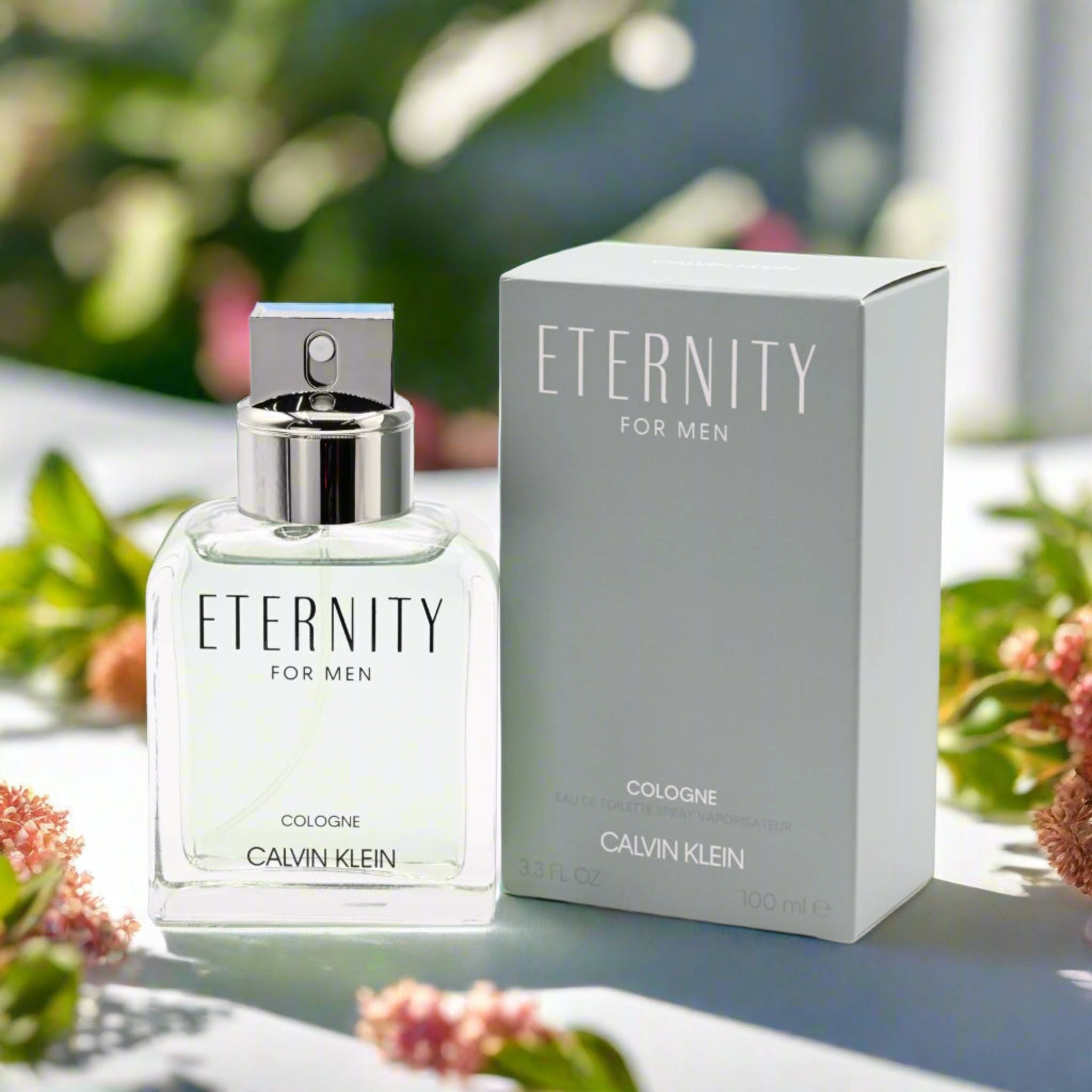 Calvin Klein Eternity cologne bottle and packaging on a table with flowers in the background
