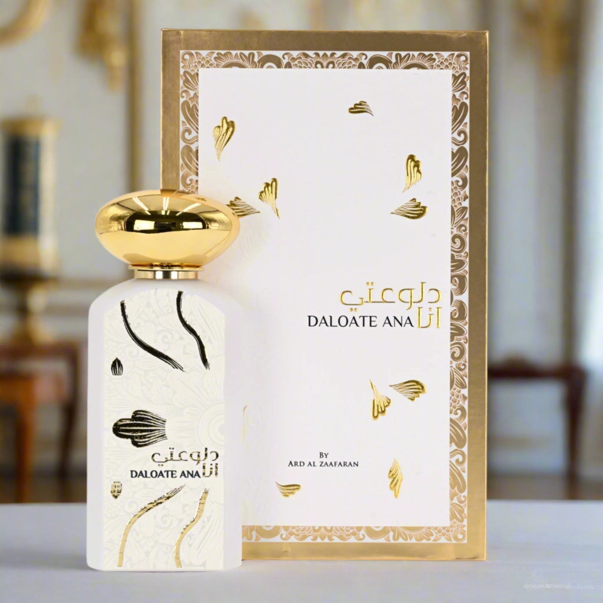 Perfume bottle and packaging with gold and white design on a blurred background