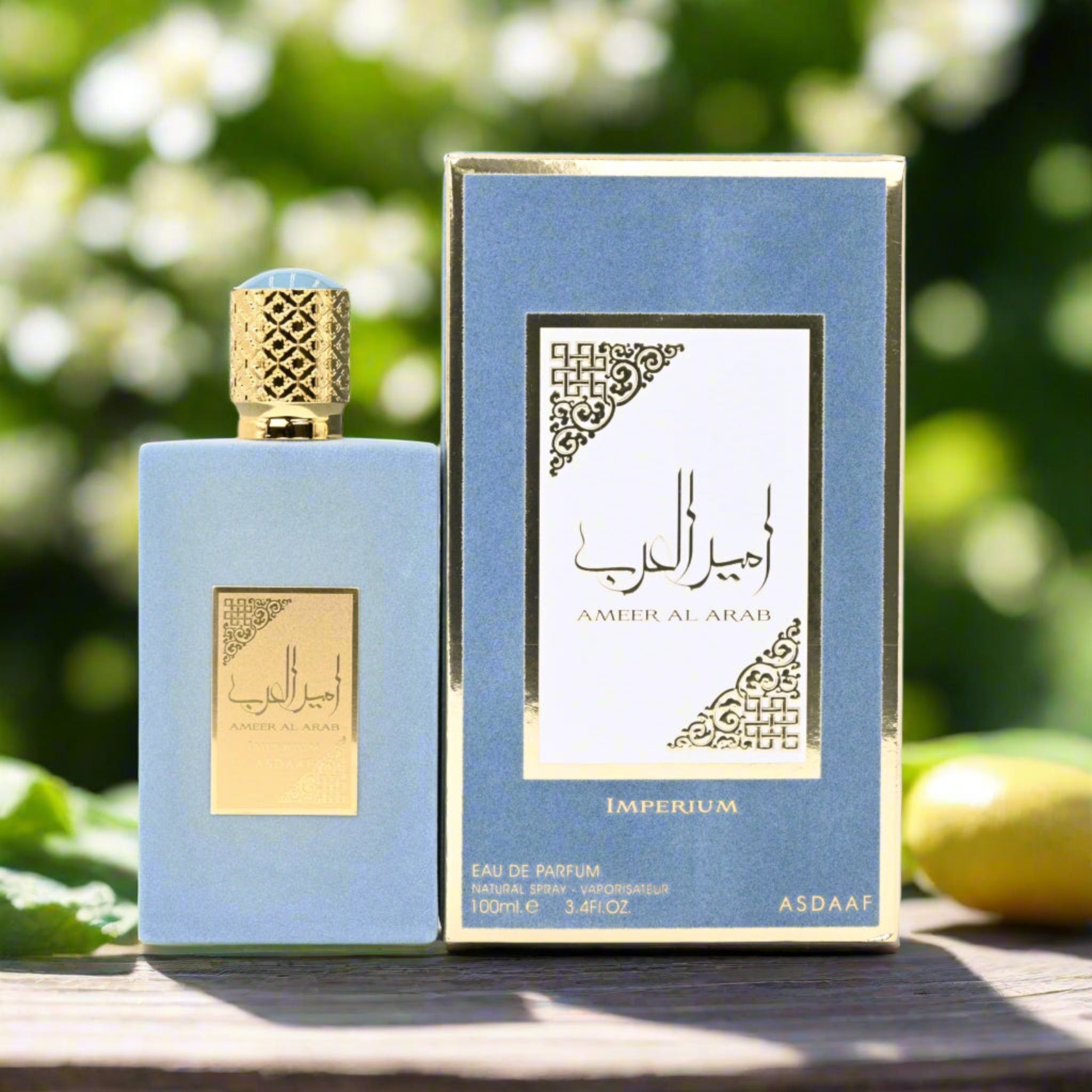 Perfume bottle and packaging with 'ASDAAF' branding against a blurred natural background