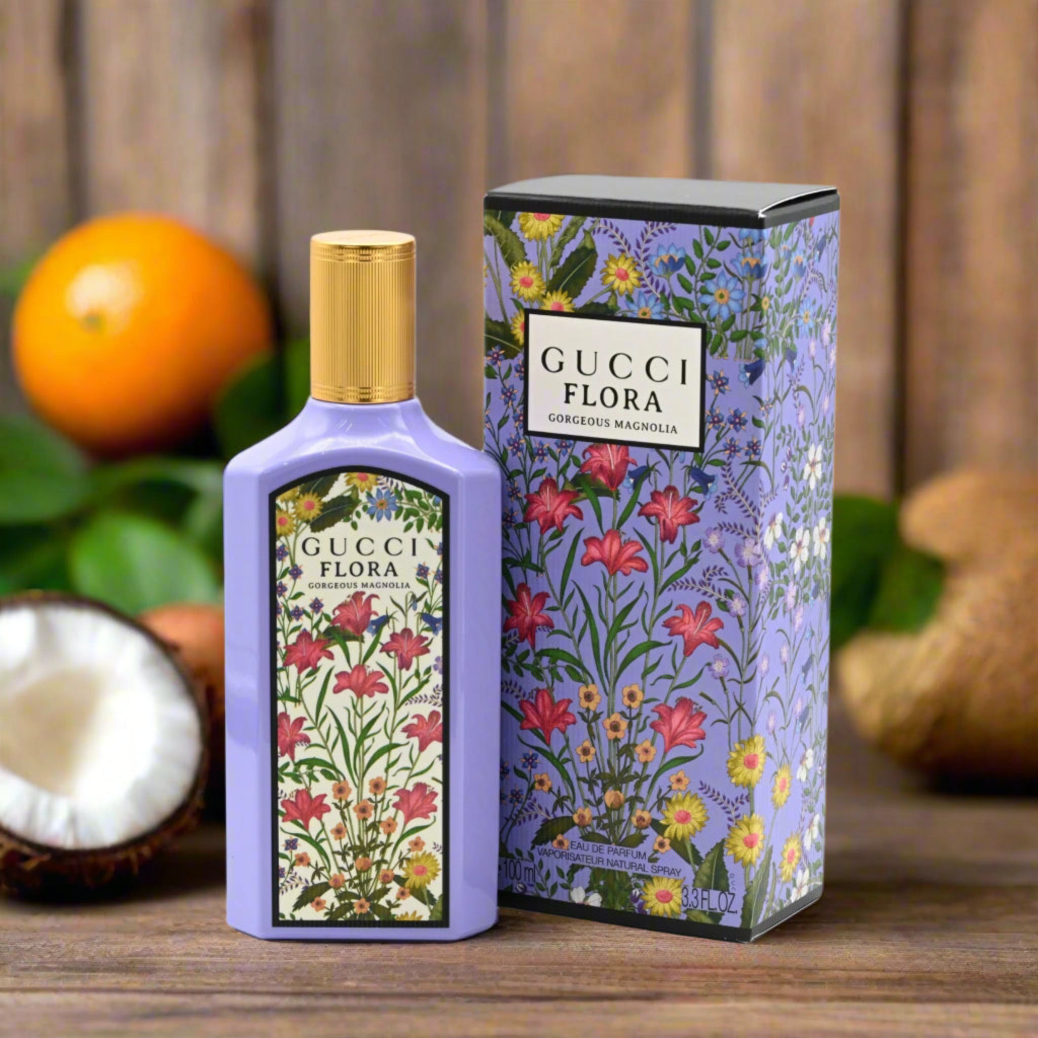 Gucci Flora perfume bottle and packaging with floral design on a wooden surface.