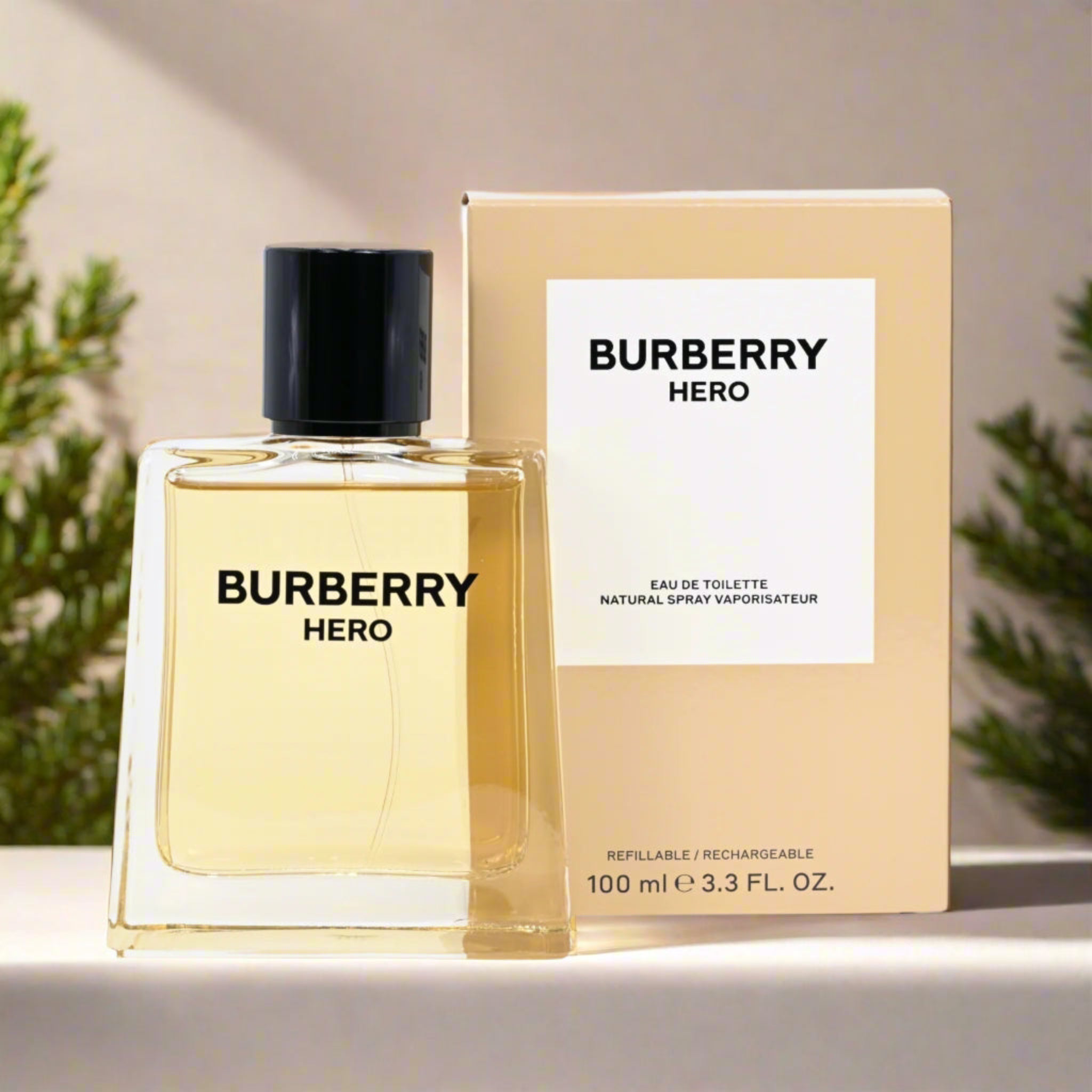 Burberry Hero perfume bottle and packaging on a neutral background with plants.