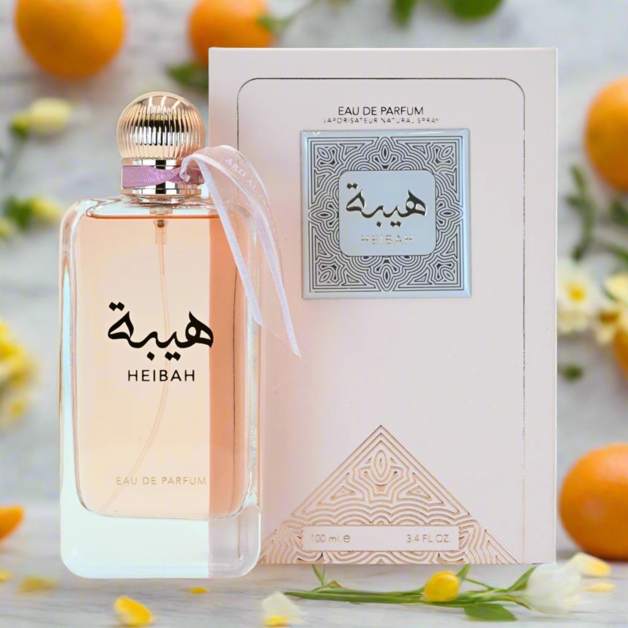 Heibah perfume bottle and packaging with oranges and flowers in the background