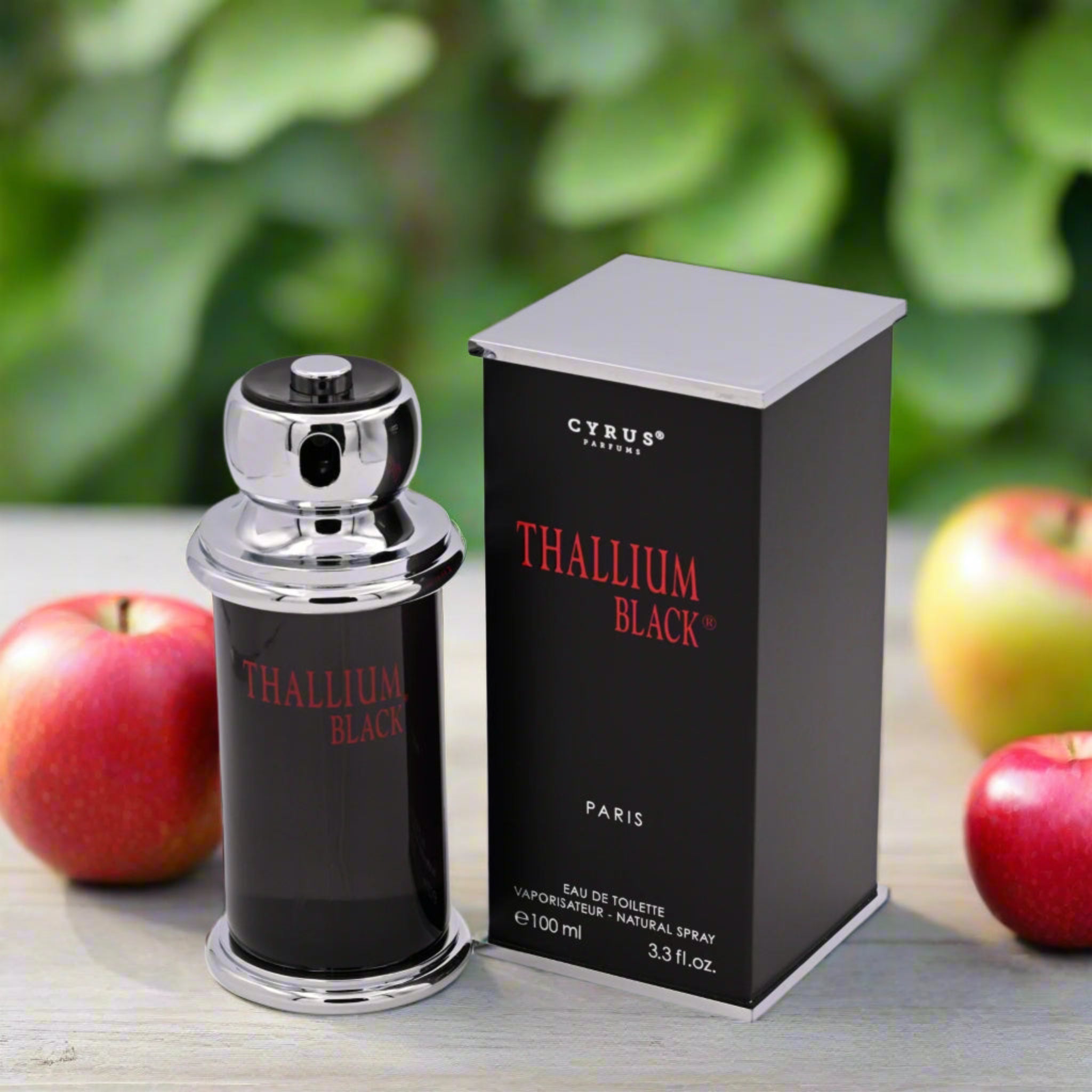 Cyrus Thallium Black perfume bottle and packaging with apples on a wooden surface