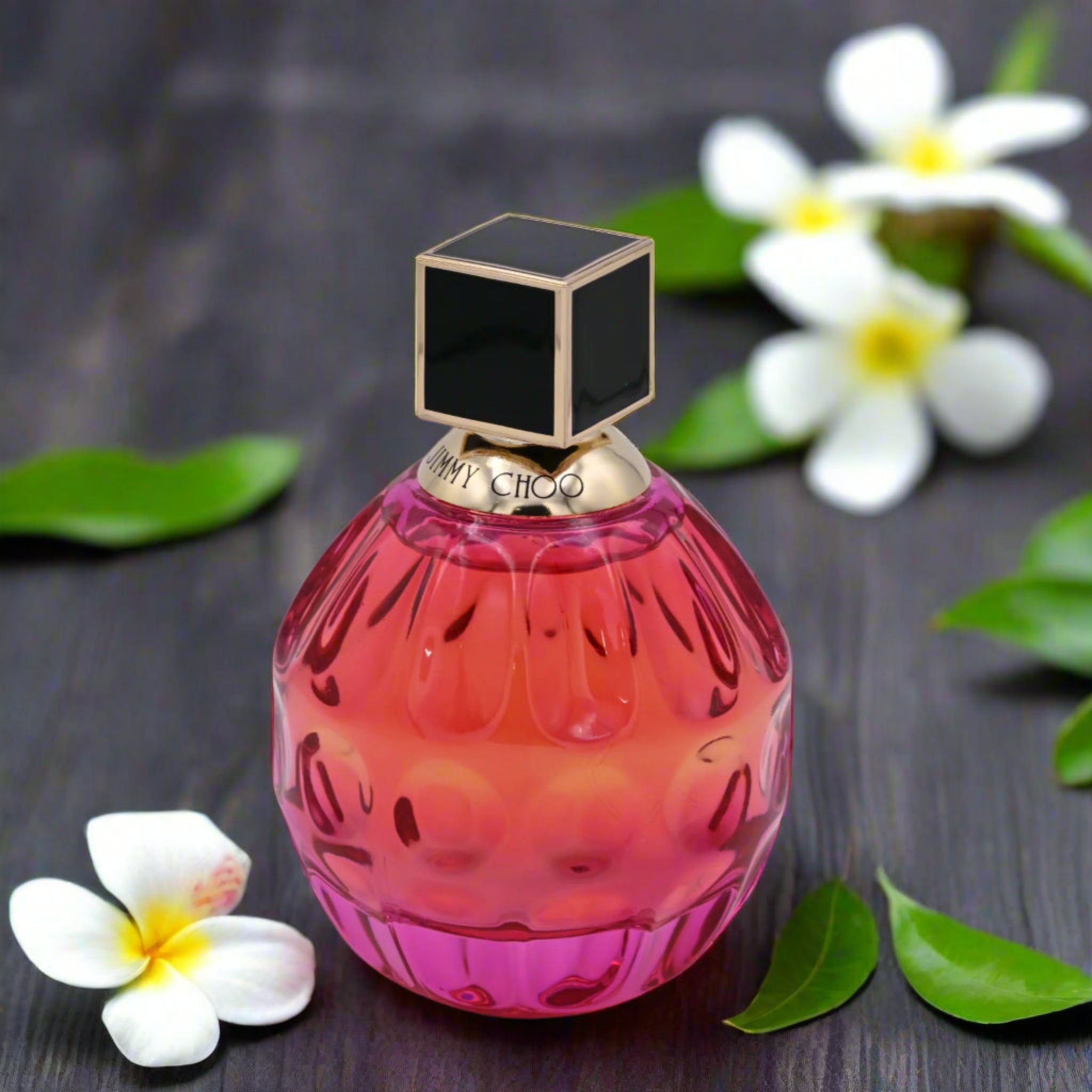 Perfume bottle with a pink and red gradient design on a white background