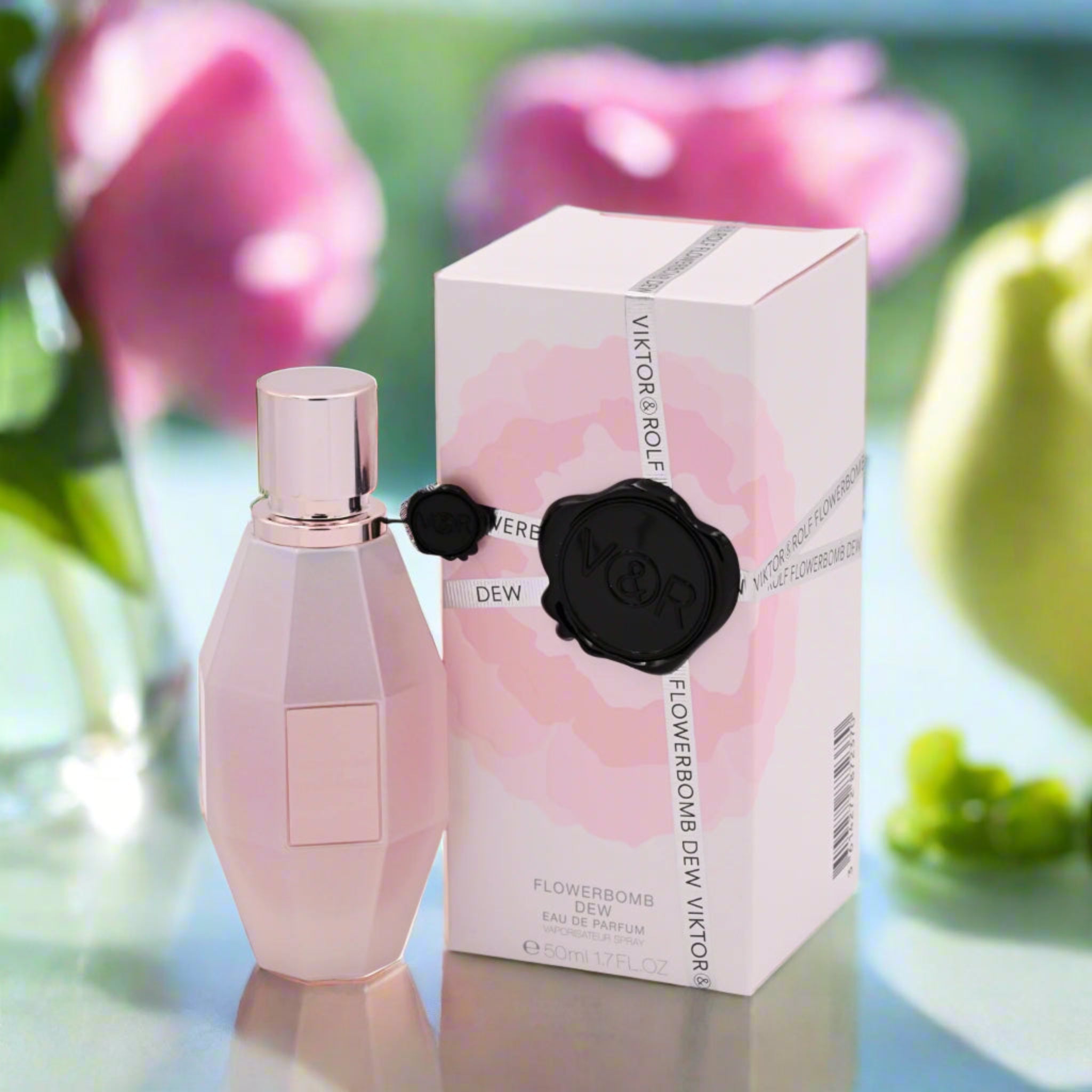 Viktor & Rolf Flowerbomb Dew perfume bottle and packaging with flowers in the background
