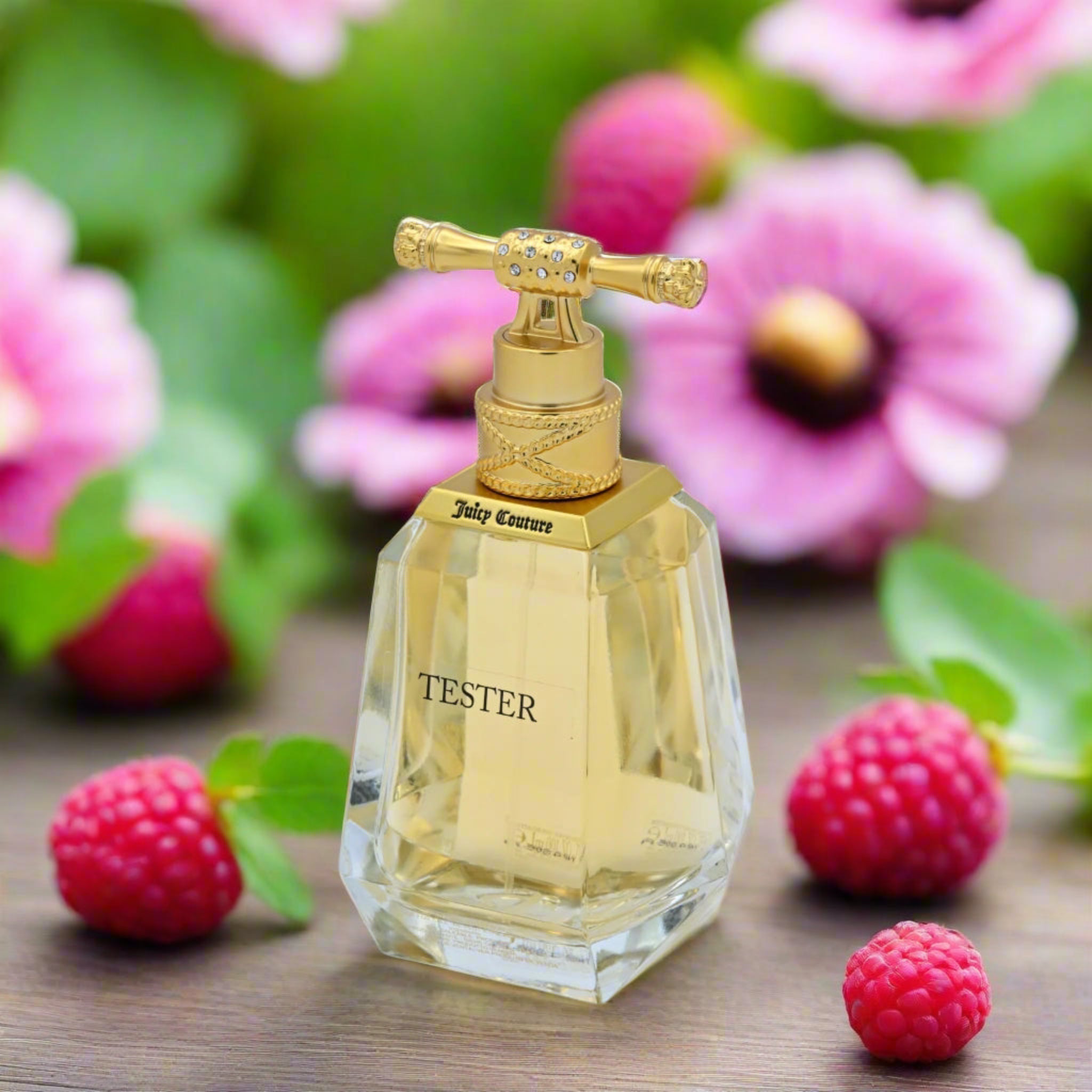 Perfume bottle with gold cap and 'Tester' label on a wooden surface with pink flowers and berries in the background