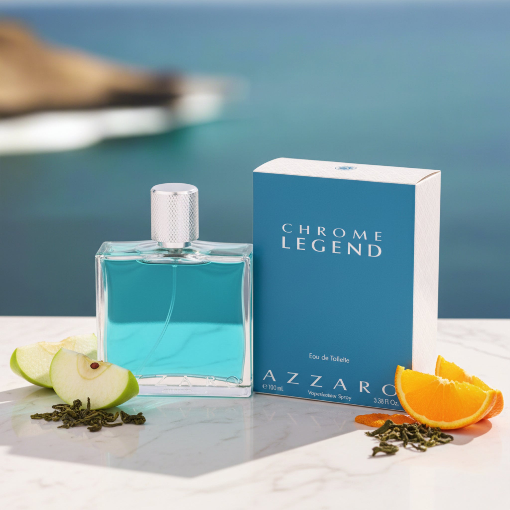 Azzaro Chrome Legend perfume bottle and packaging with a blurred coastal background