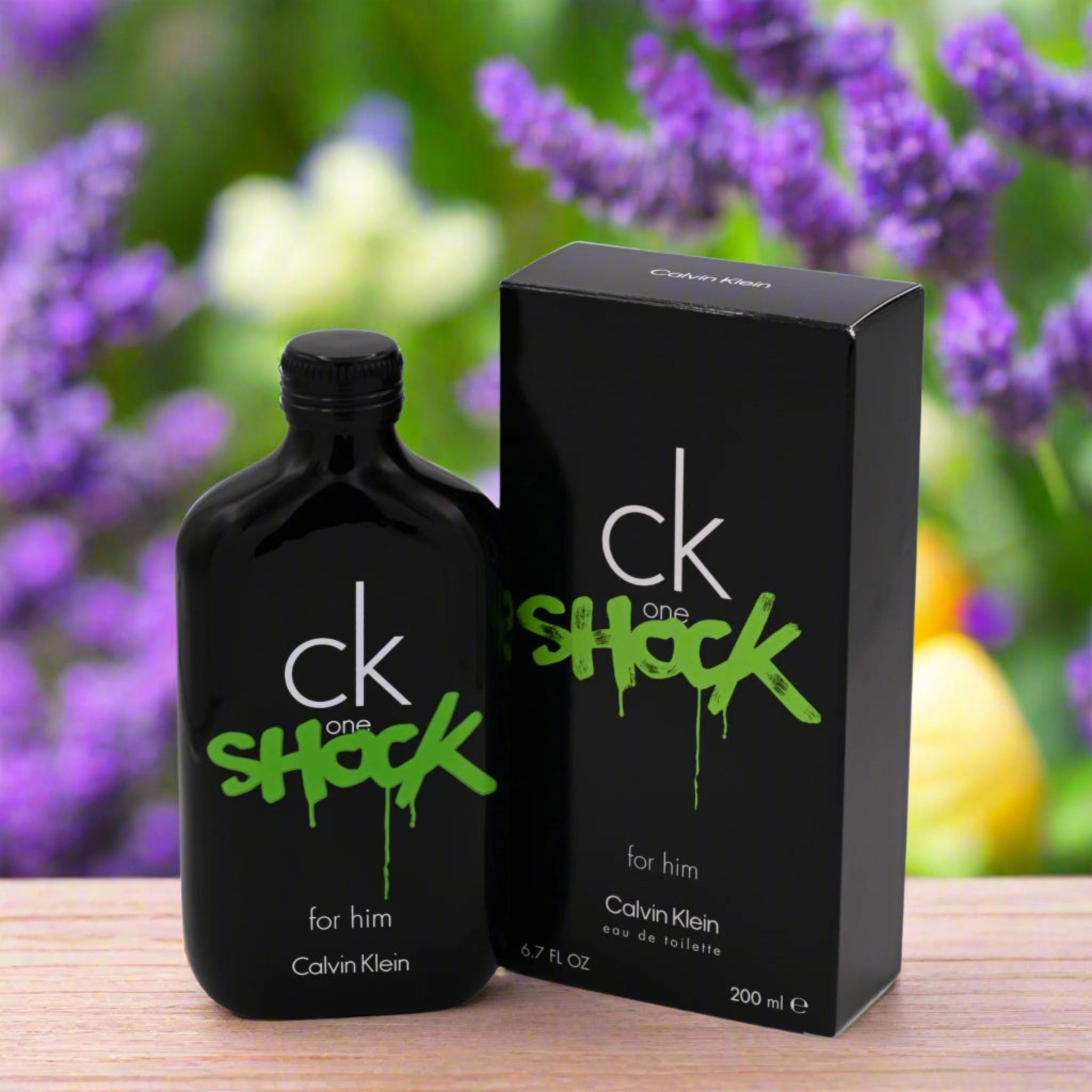 Calvin Klein CK One Shock perfume bottle and packaging with a blurred floral background