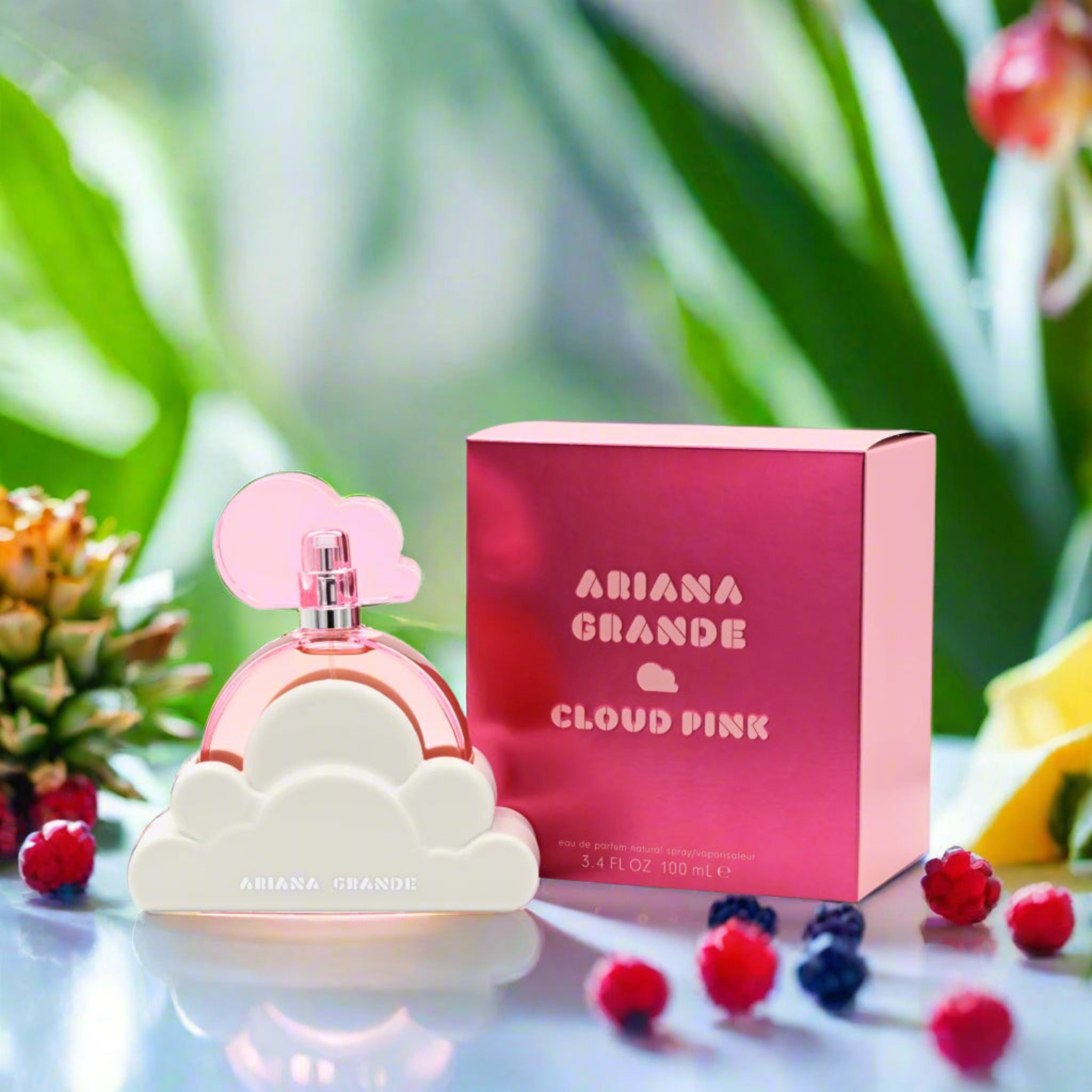 Ariana Grande Cloud Pink perfume bottle and packaging with fruits and leaves in the background