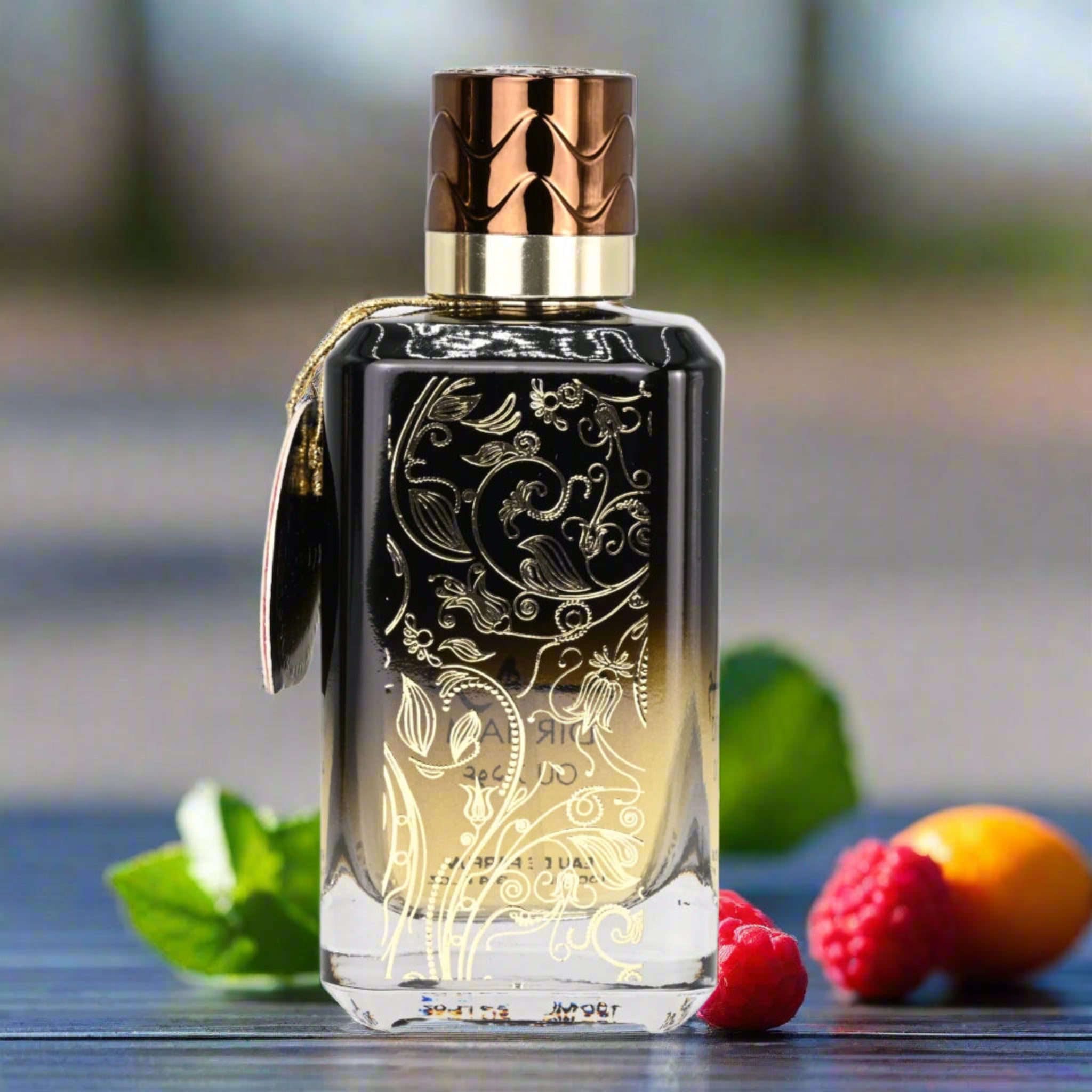Decorative perfume bottle with intricate designs on a blurred natural background