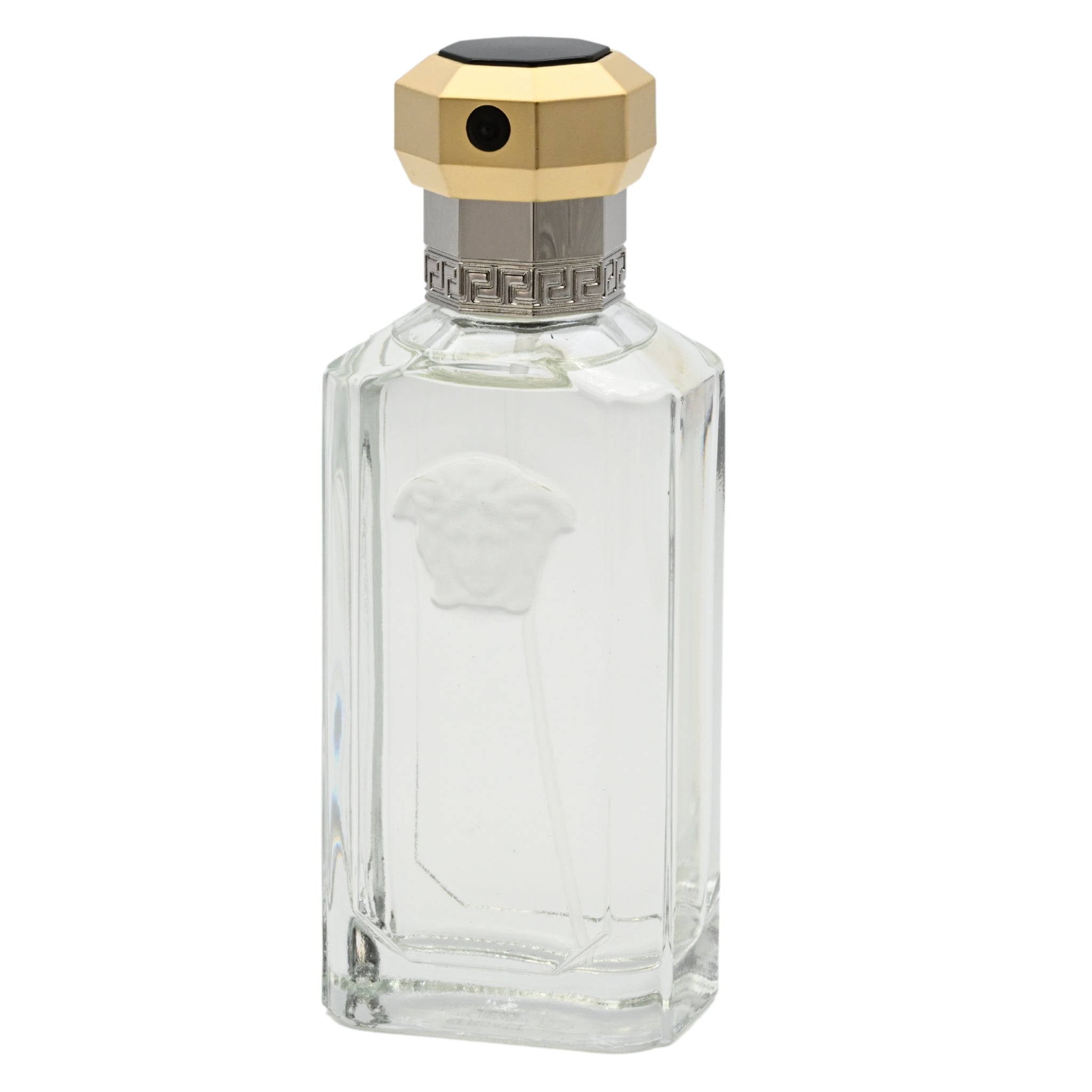 Clear glass perfume bottle with gold and silver cap on a white background