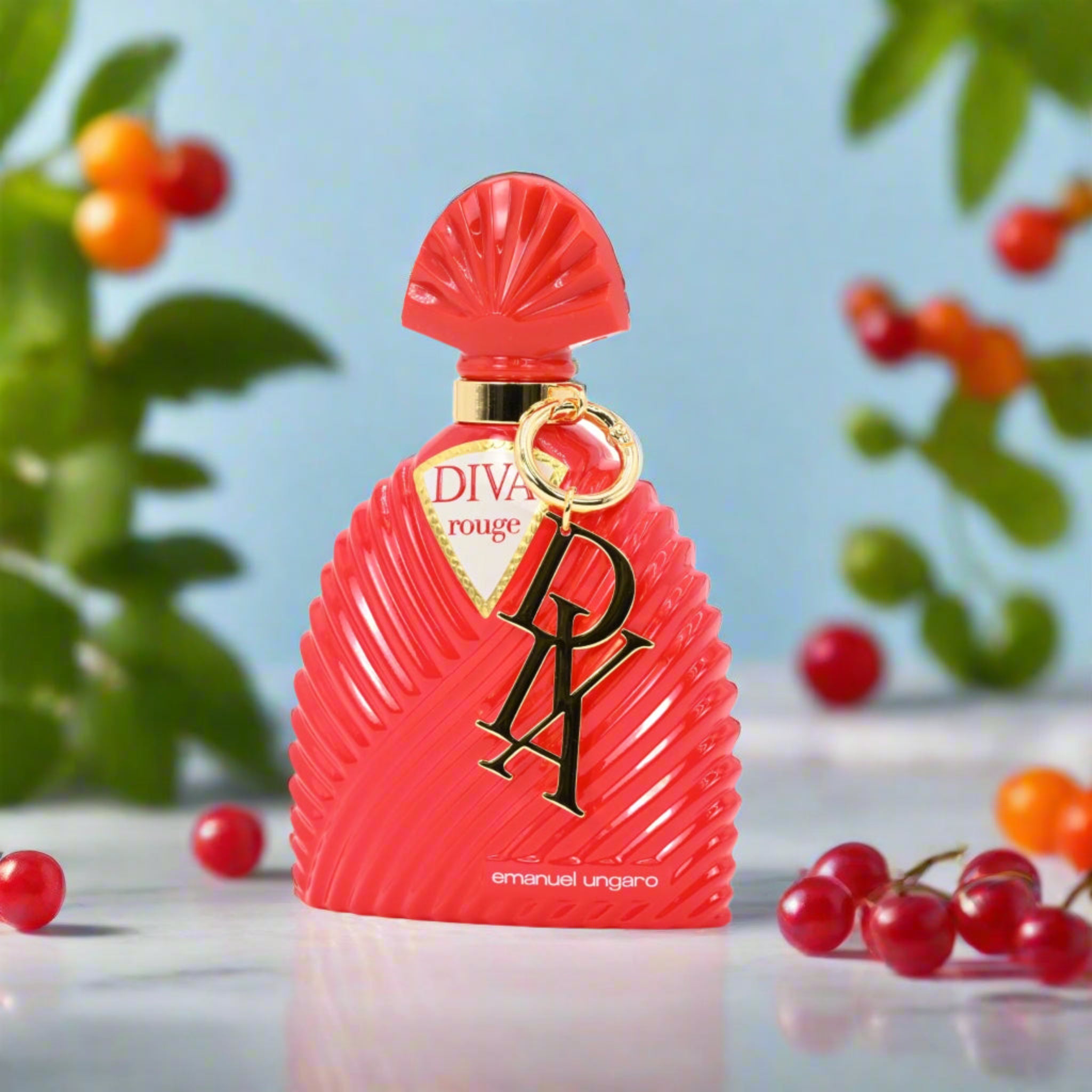 Red perfume bottle with 'DIVA' branding on a light blue background with berries and leaves.