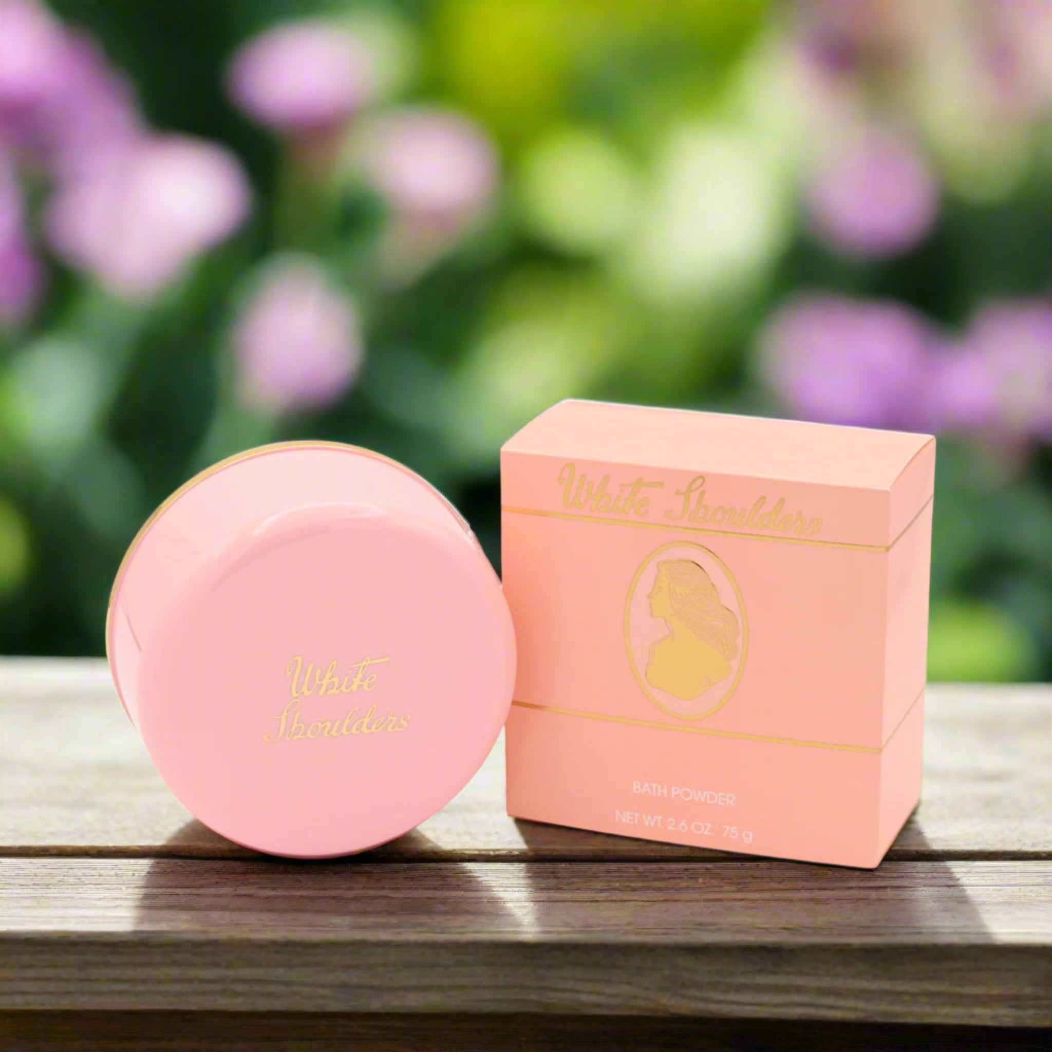 Pink cosmetic product and packaging on a wooden surface with a blurred floral background