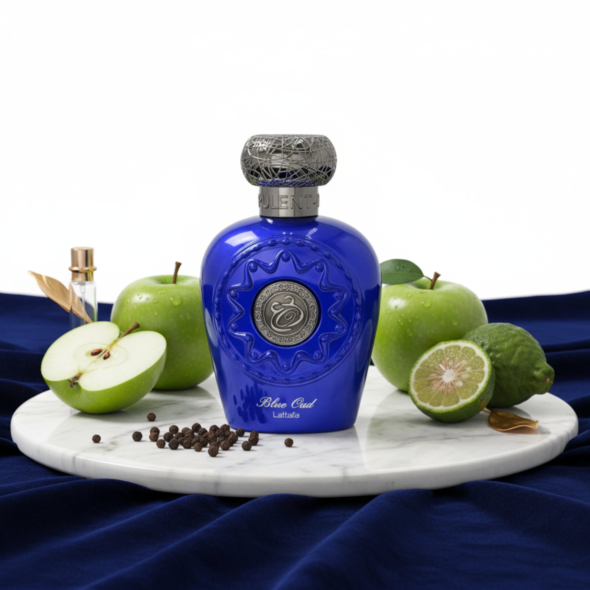 Blue perfume bottle with silver cap on a white background