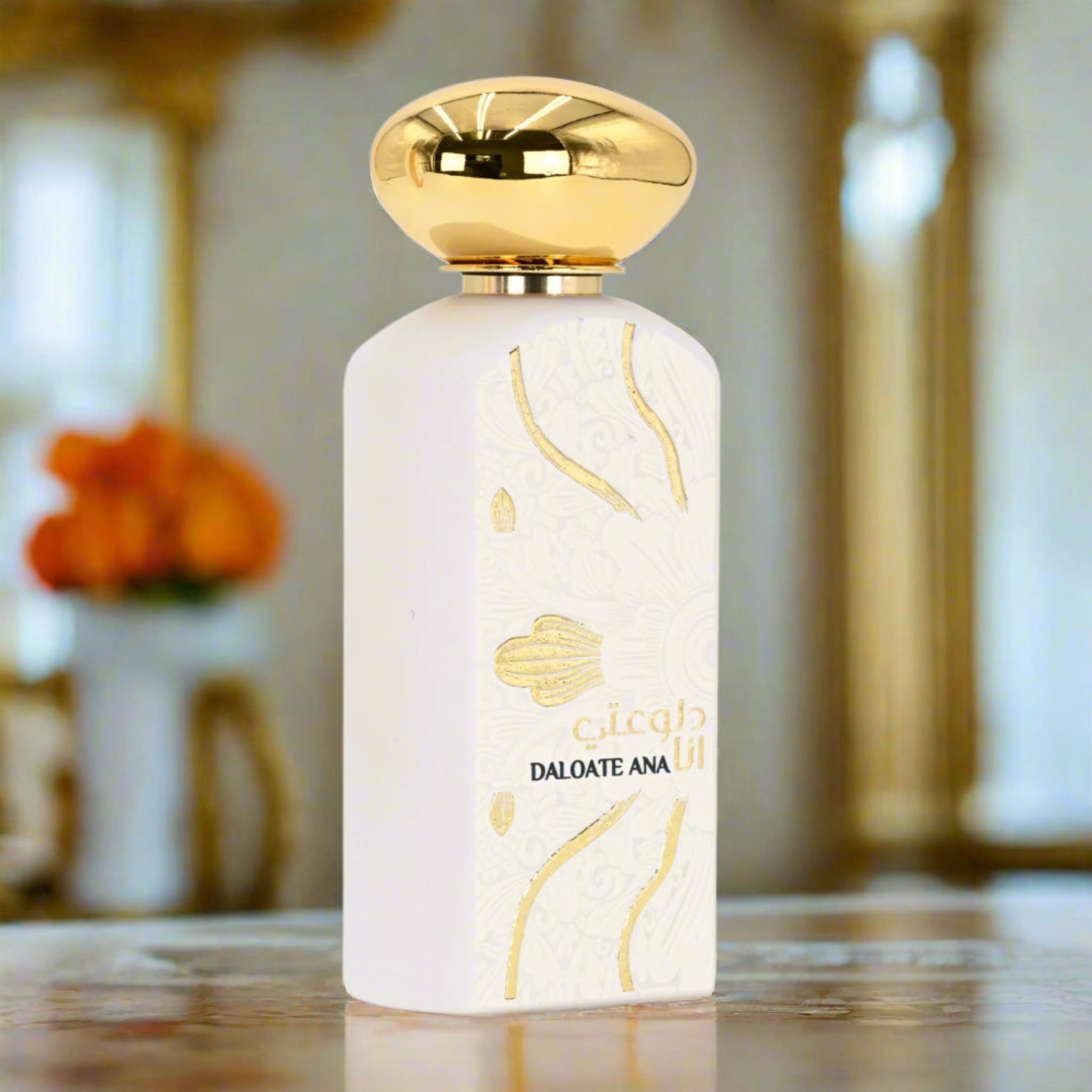 Perfume bottle with gold cap and decorative design on a blurred background