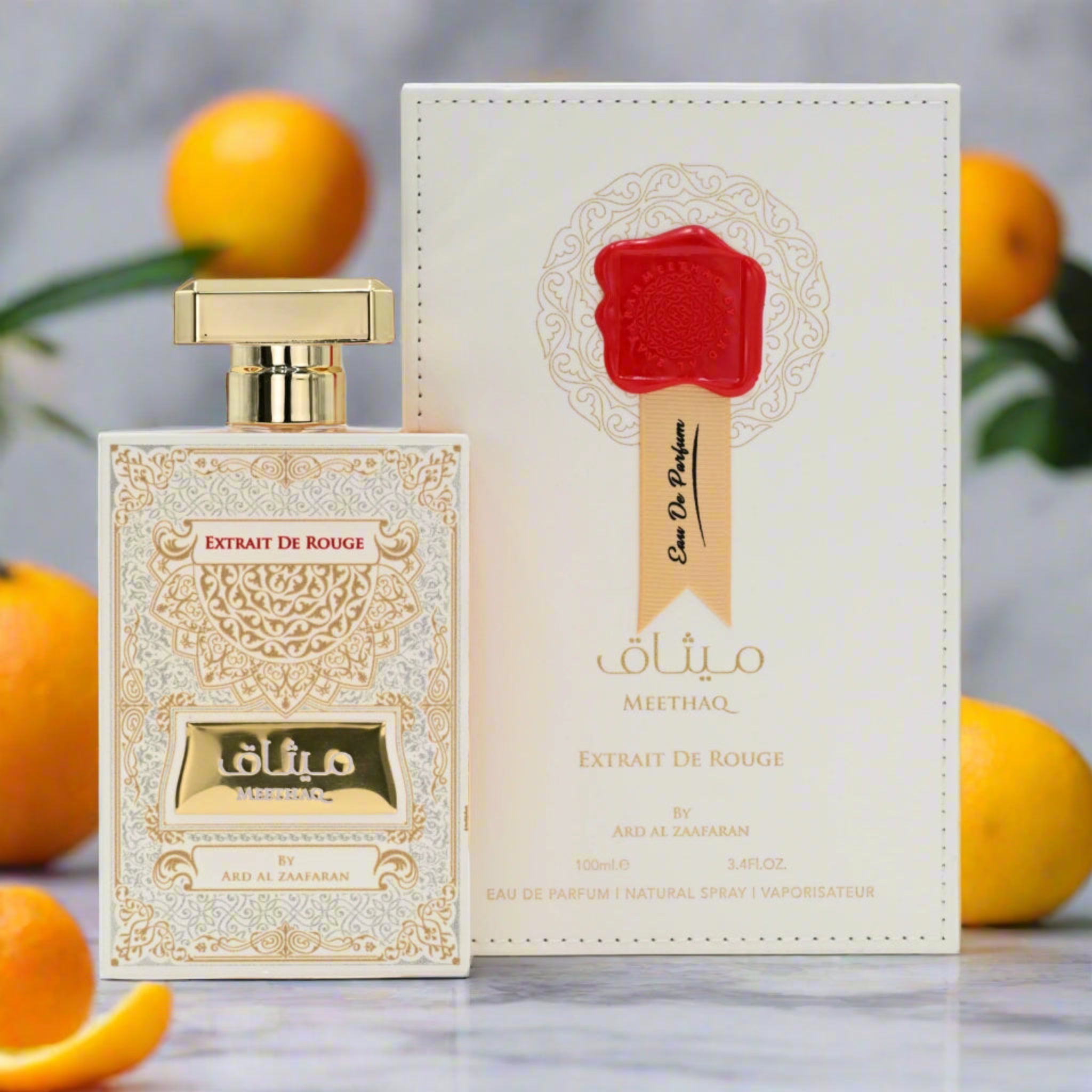 Perfume bottle and packaging with oranges on a marble surface