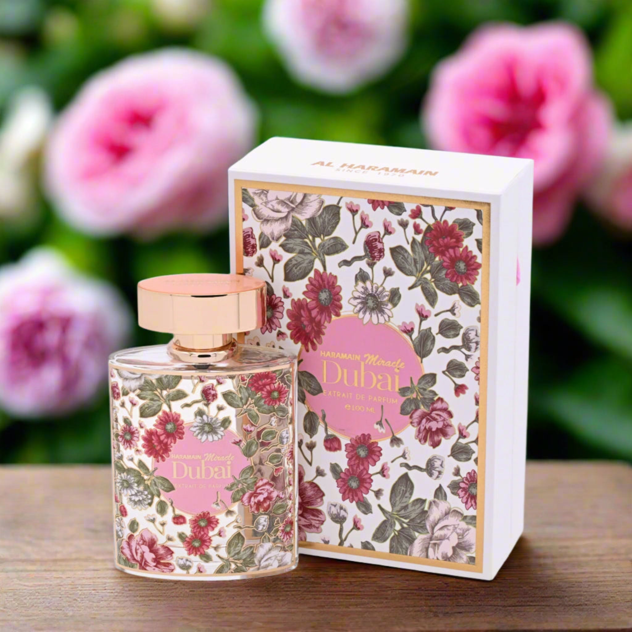Floral perfume bottle and packaging with pink flowers in the background