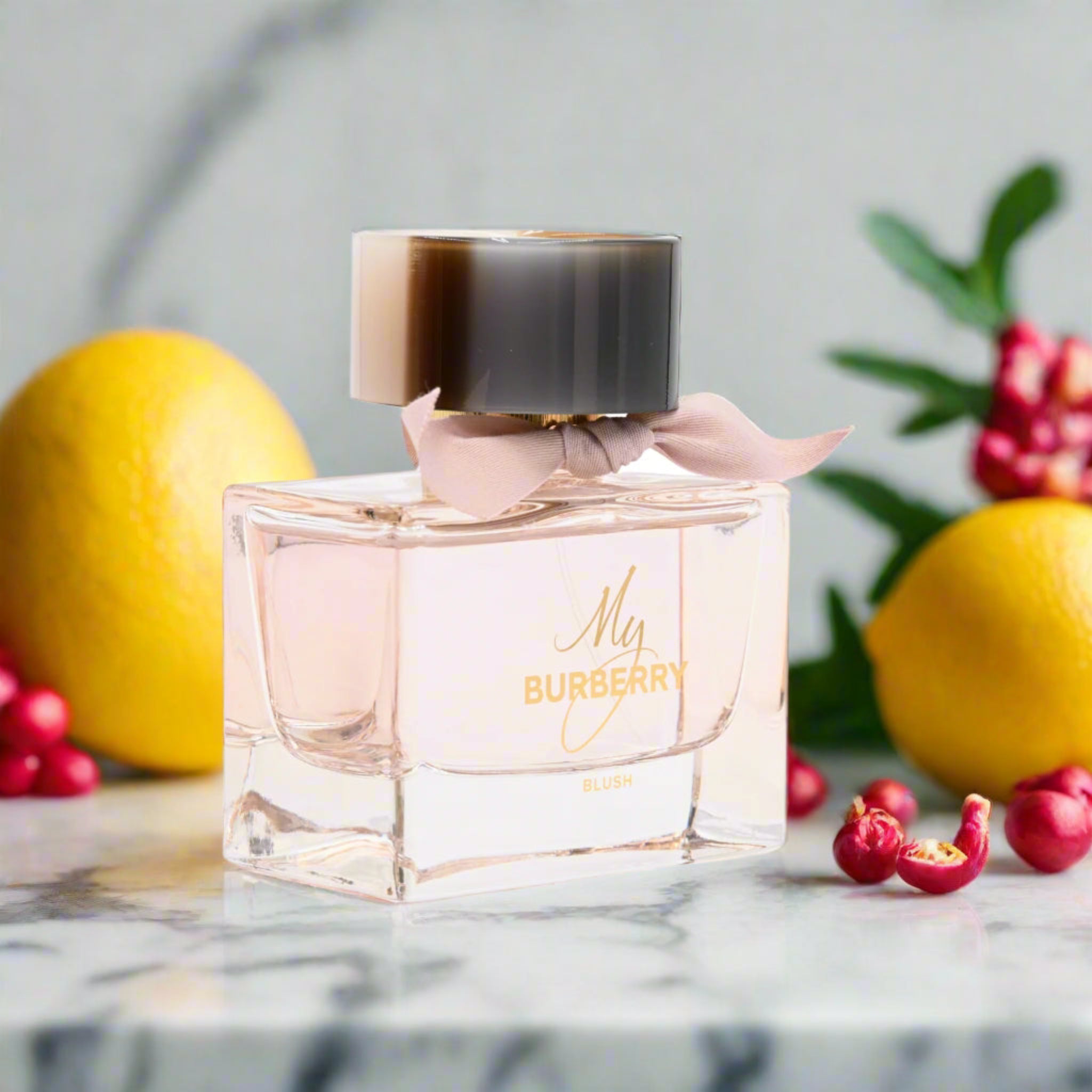 My Burberry Blush perfume bottle on a blurred background with fruits
