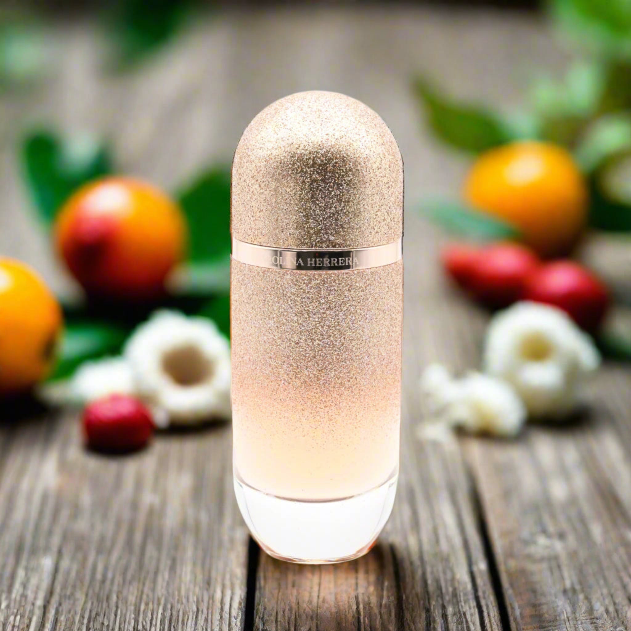 Decorative bottle with glittery texture on a wooden surface with fruits and flowers in the background