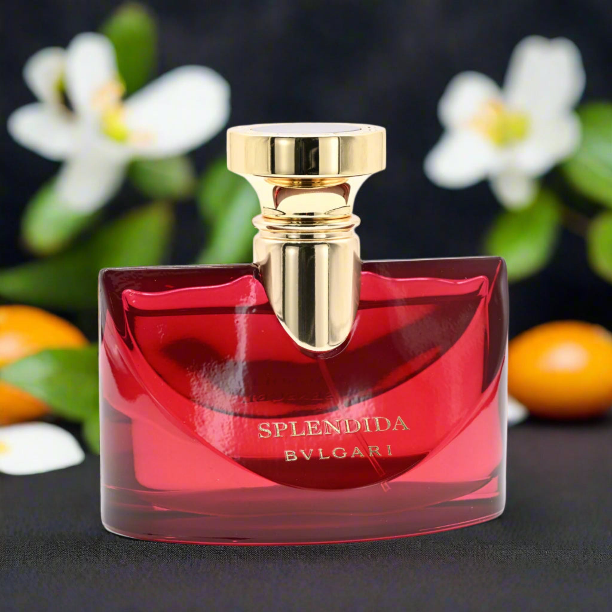 Bulgari Splendida perfume bottle with a gold cap against a floral background