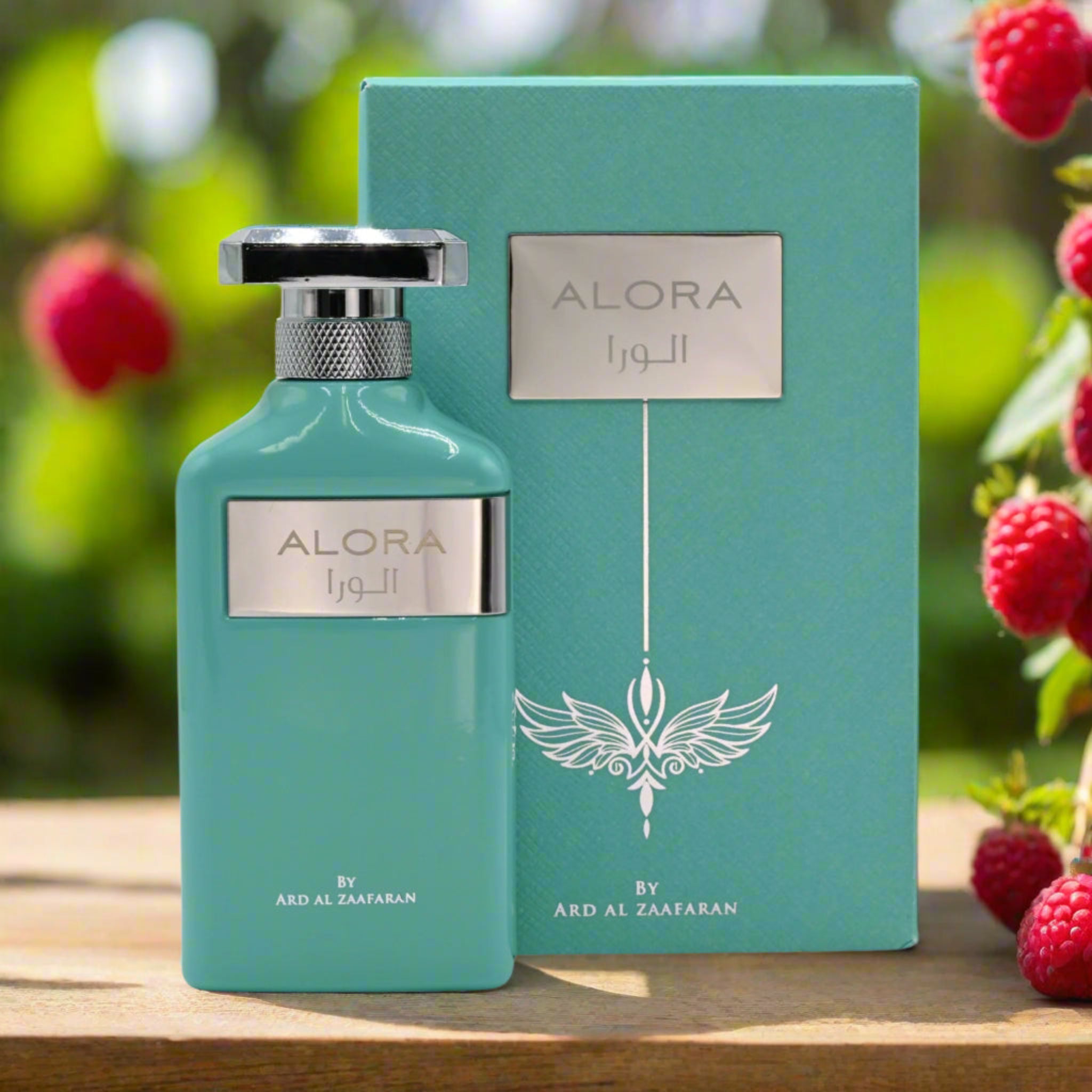 Alora perfume bottle and packaging with a blurred natural background
