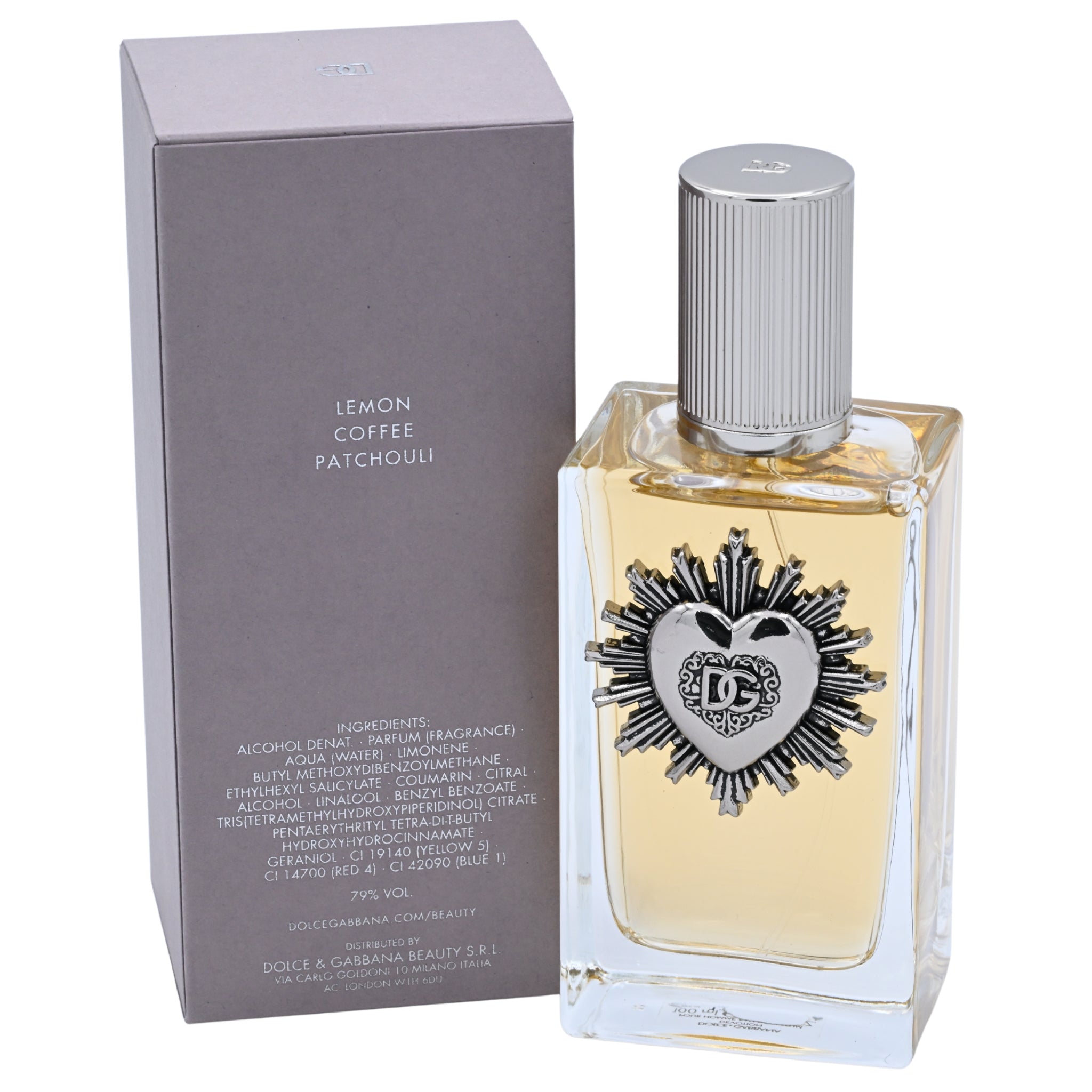 Perfume bottle with silver cap and decorative label next to its packaging on a white background